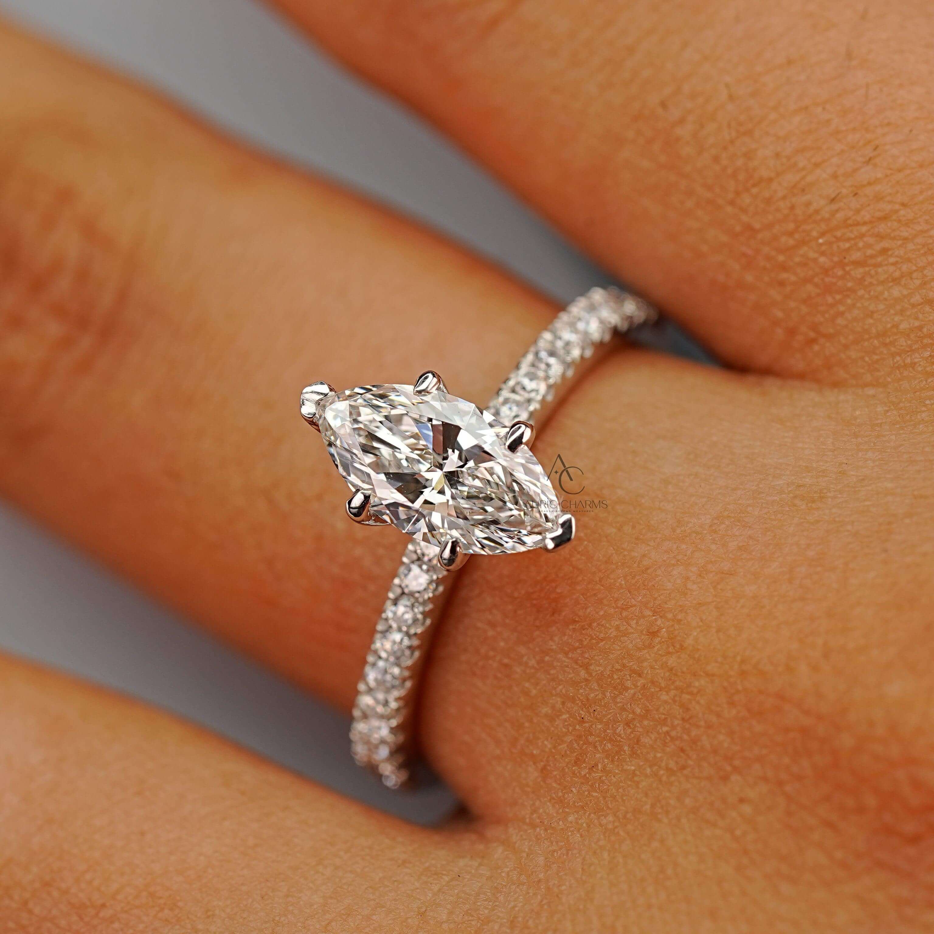 A marquise-cut diamond ring modeled on a finger, emphasizing its sparkle and sophisticated design.