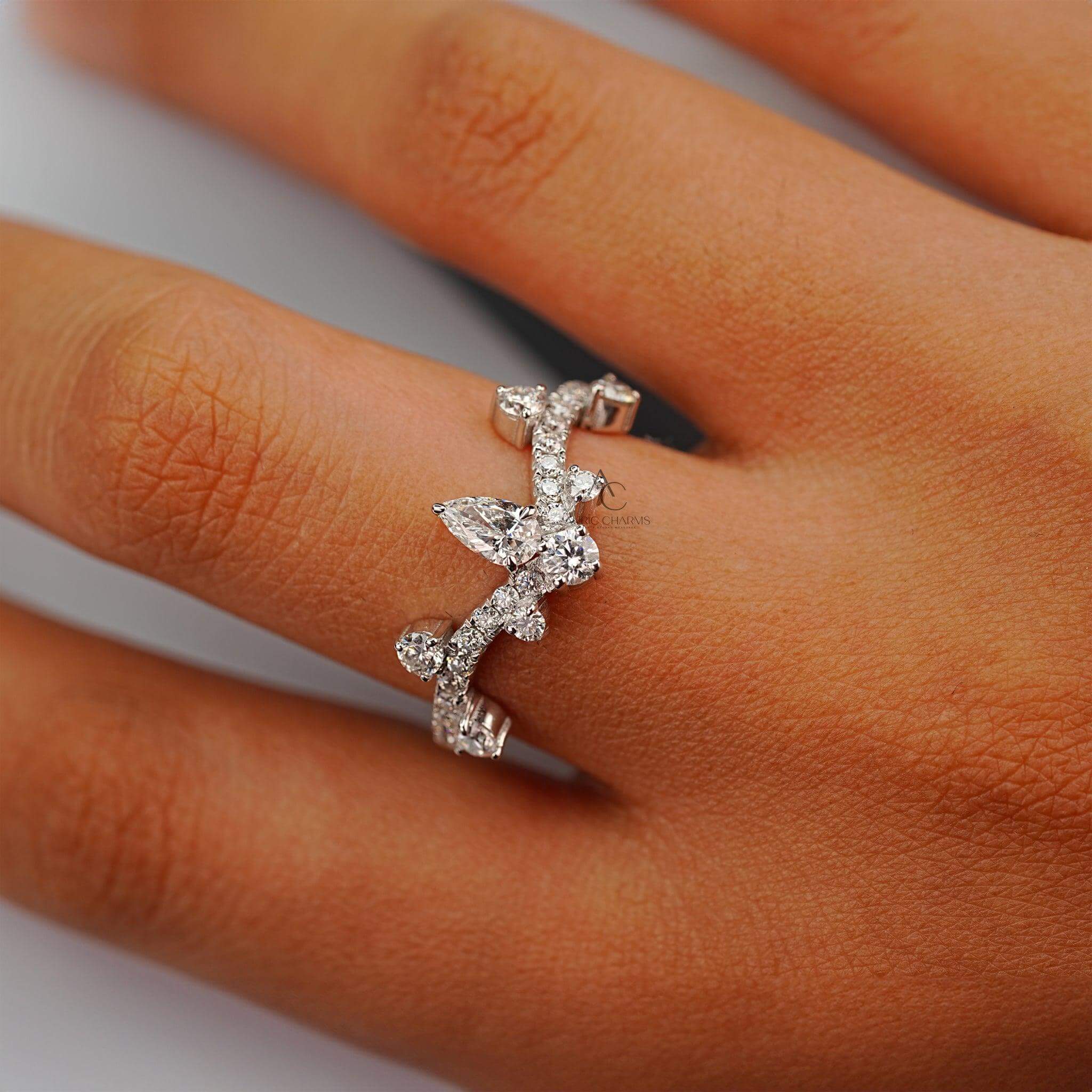 Diamond crown ring with pear-shaped centerpiece elegantly worn on a hand.