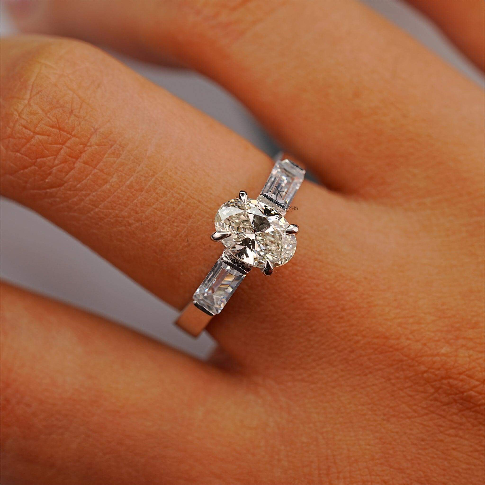 Oval diamond engagement ring with baguettes, perfectly displayed on a hand for a luxury look.
