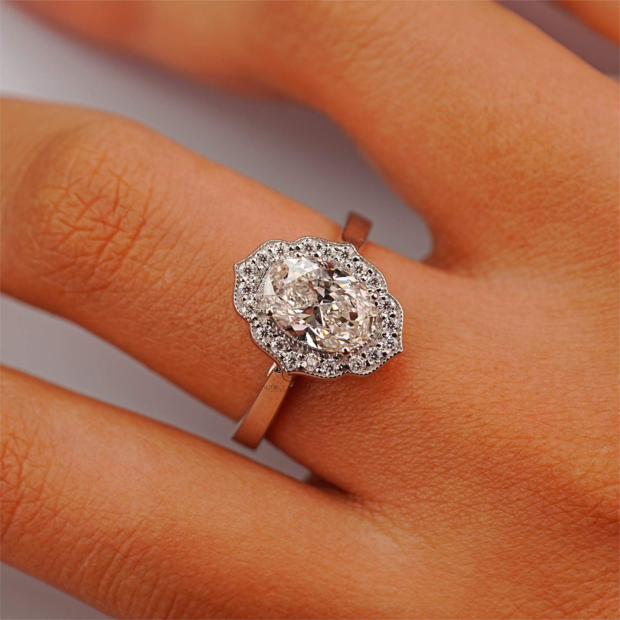 Luxury oval-shaped halo diamond ring elegantly displayed on a finger.
