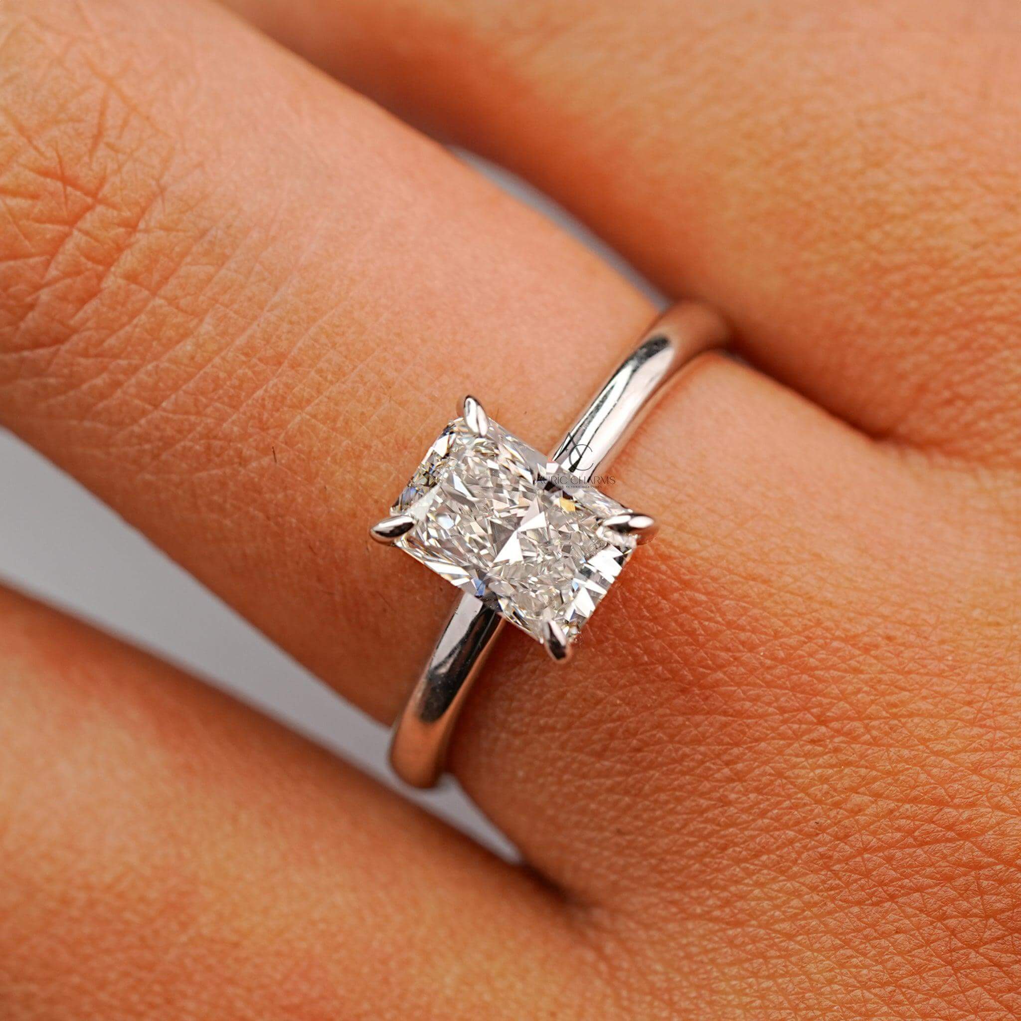 Radiant-cut diamond solitaire ring on finger, highlighting brilliance and timeless design.