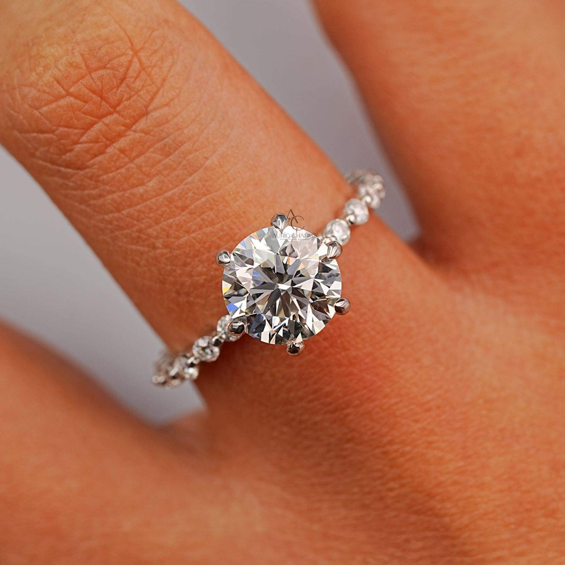 Close-up of round-cut diamond engagement ring with a matching diamond band.