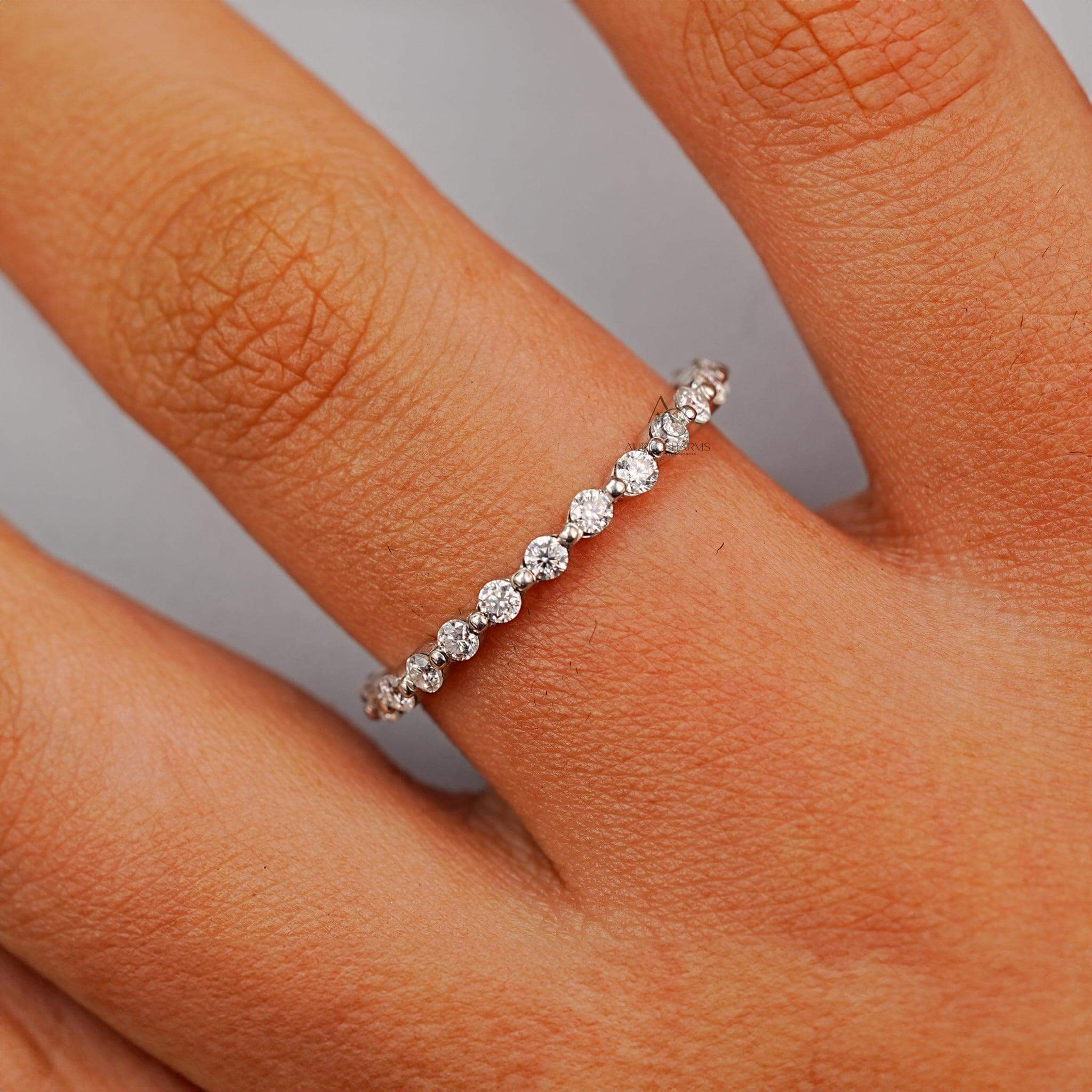 Close-up of a diamond eternity band in a prong setting, showcasing brilliance.