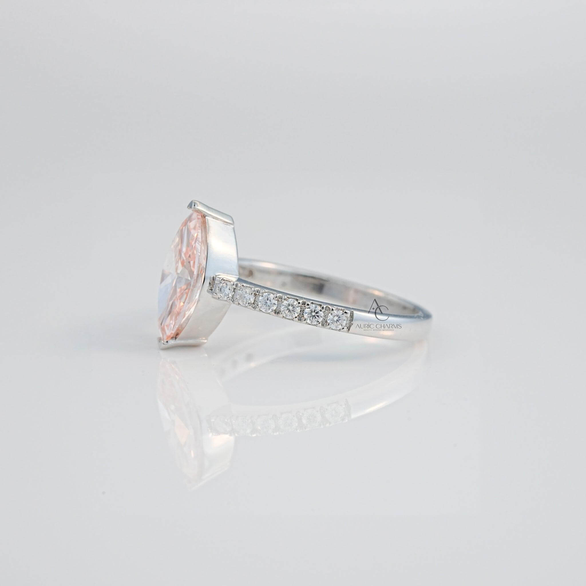 Elegant pink gemstone ring with diamonds showcased in a rear angle, set in silver.