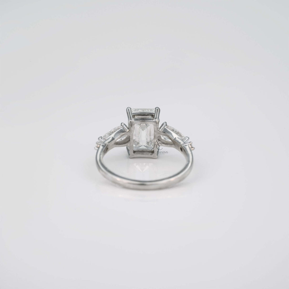 Back view of emerald cut lab diamond ring, showcasing gallery and prongs.