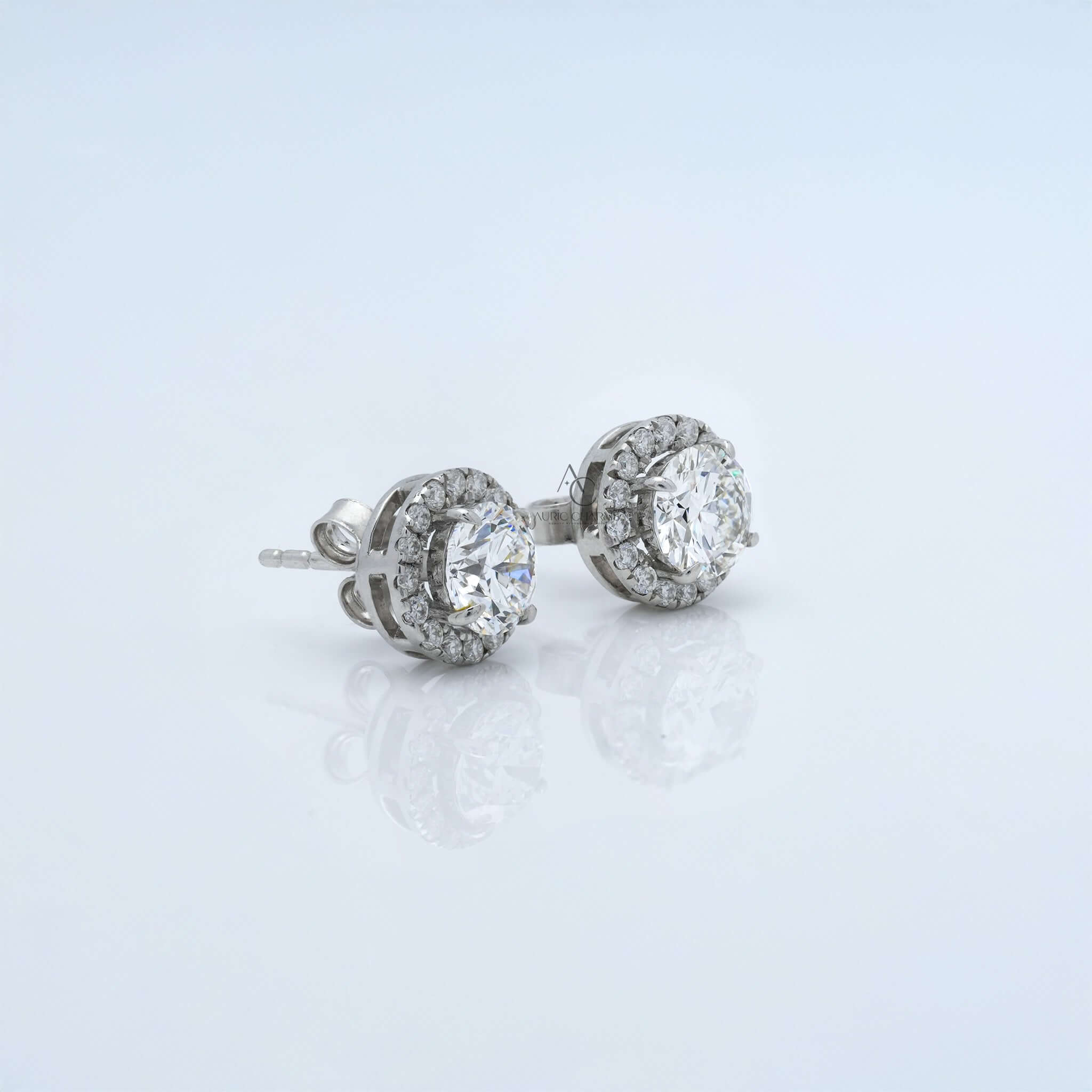 Round diamond halo earrings with brilliant diamonds in a secure setting.