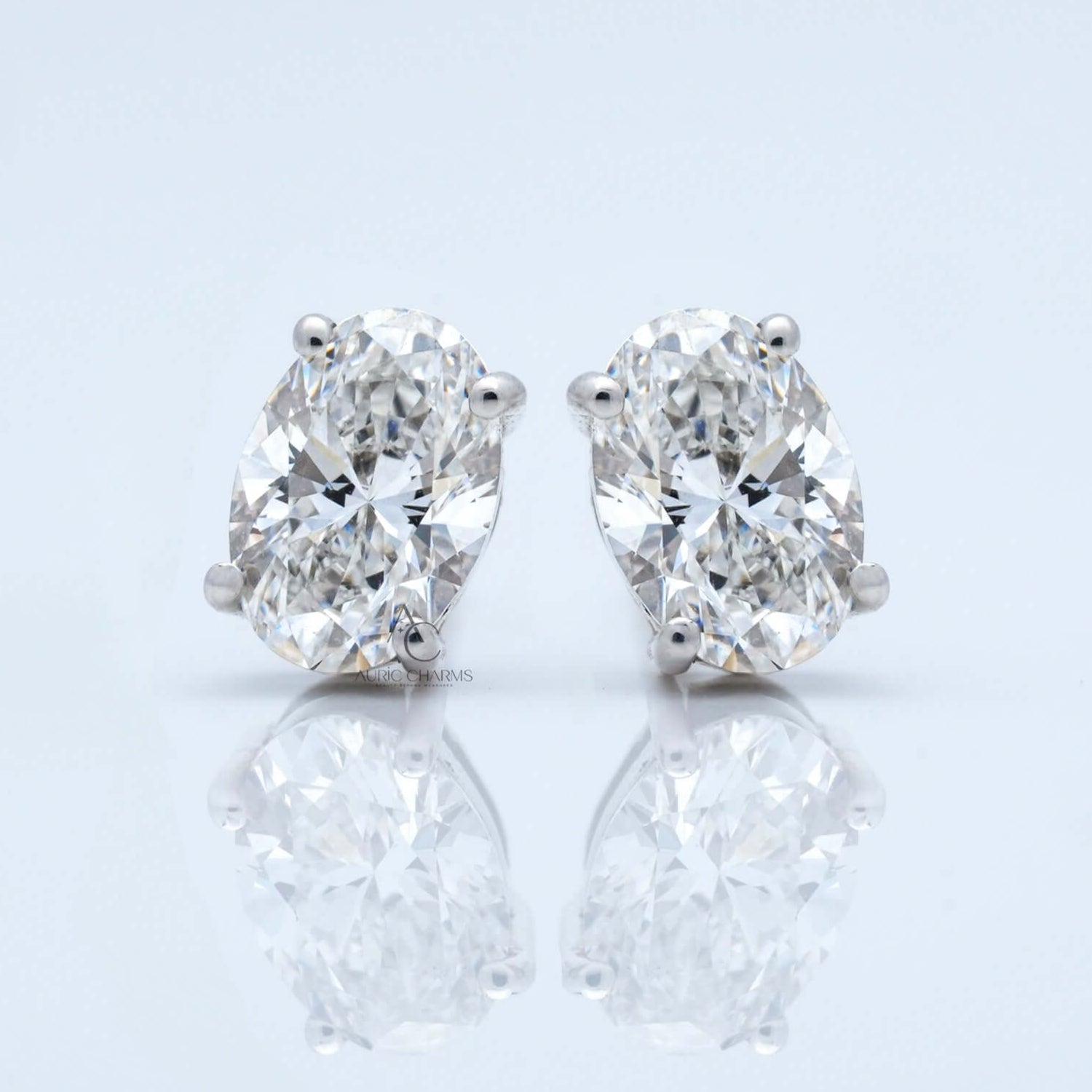 Front view of oval diamond stud earrings with clarity in white gold.