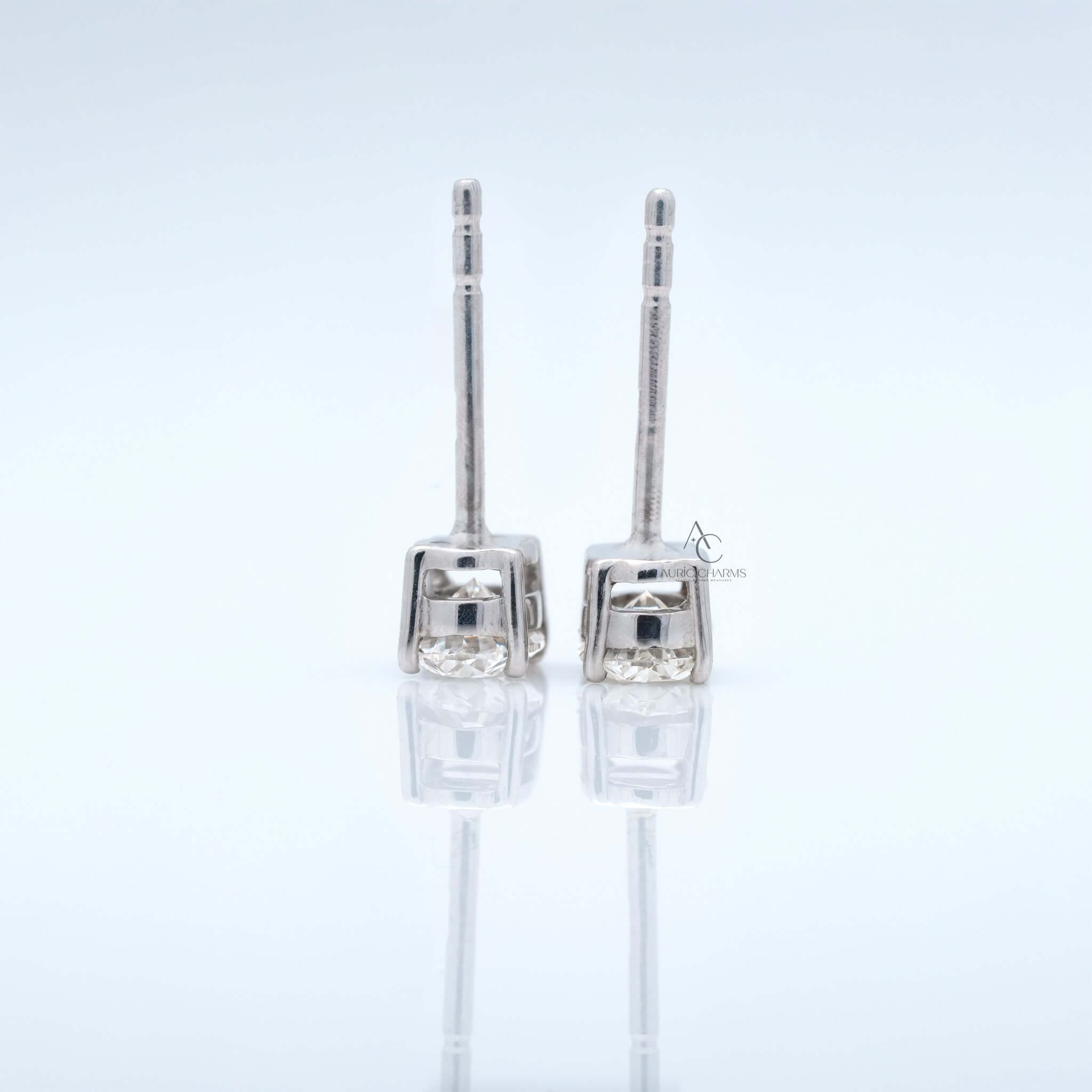 Back view of oval diamond earrings showing prong setting and post design.