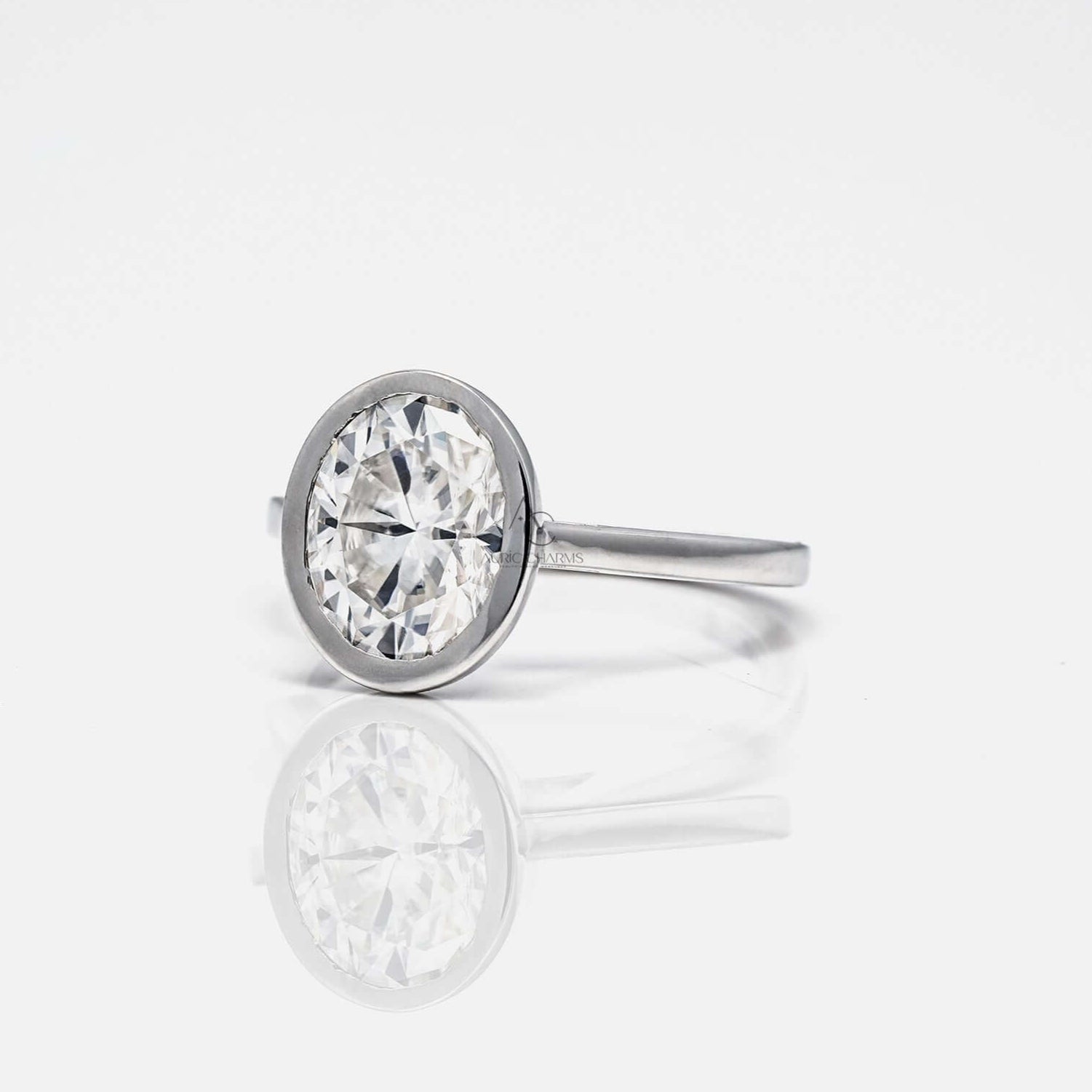 Side view of oval diamond ring with sleek silver band.
