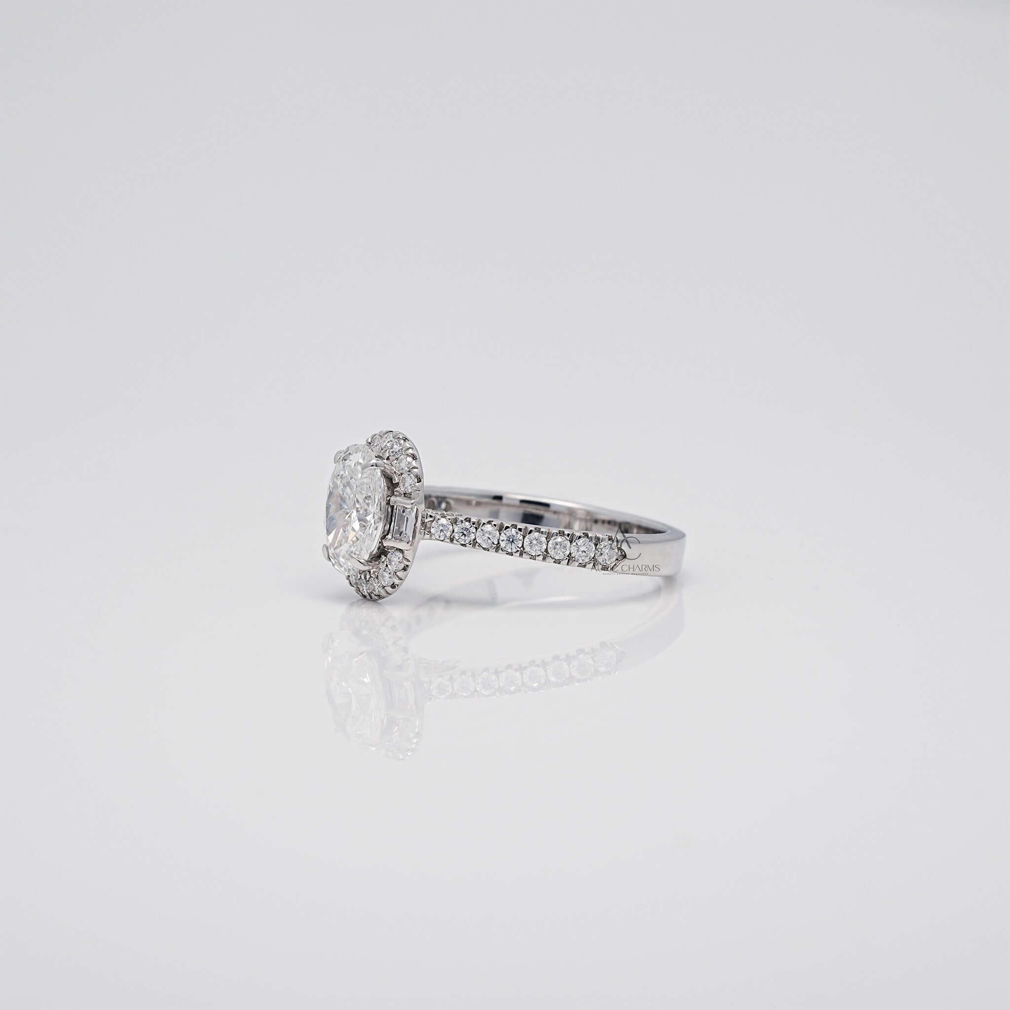 Angled side view of oval diamond ring with baguette and pave band.