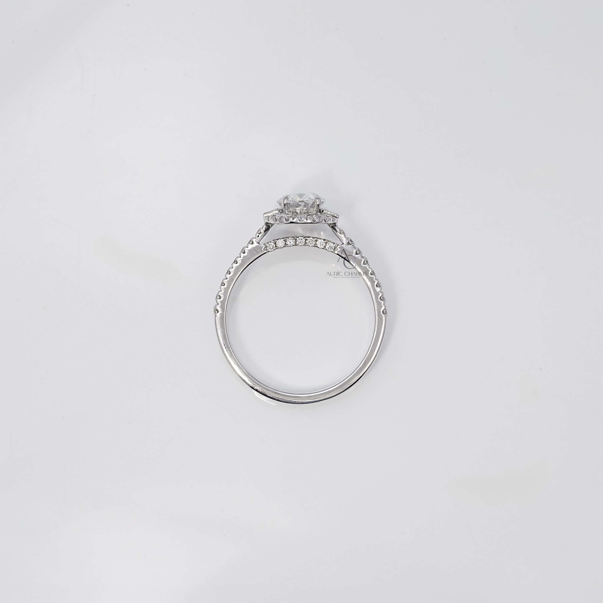 Top view of oval diamond ring showing band and halo design.