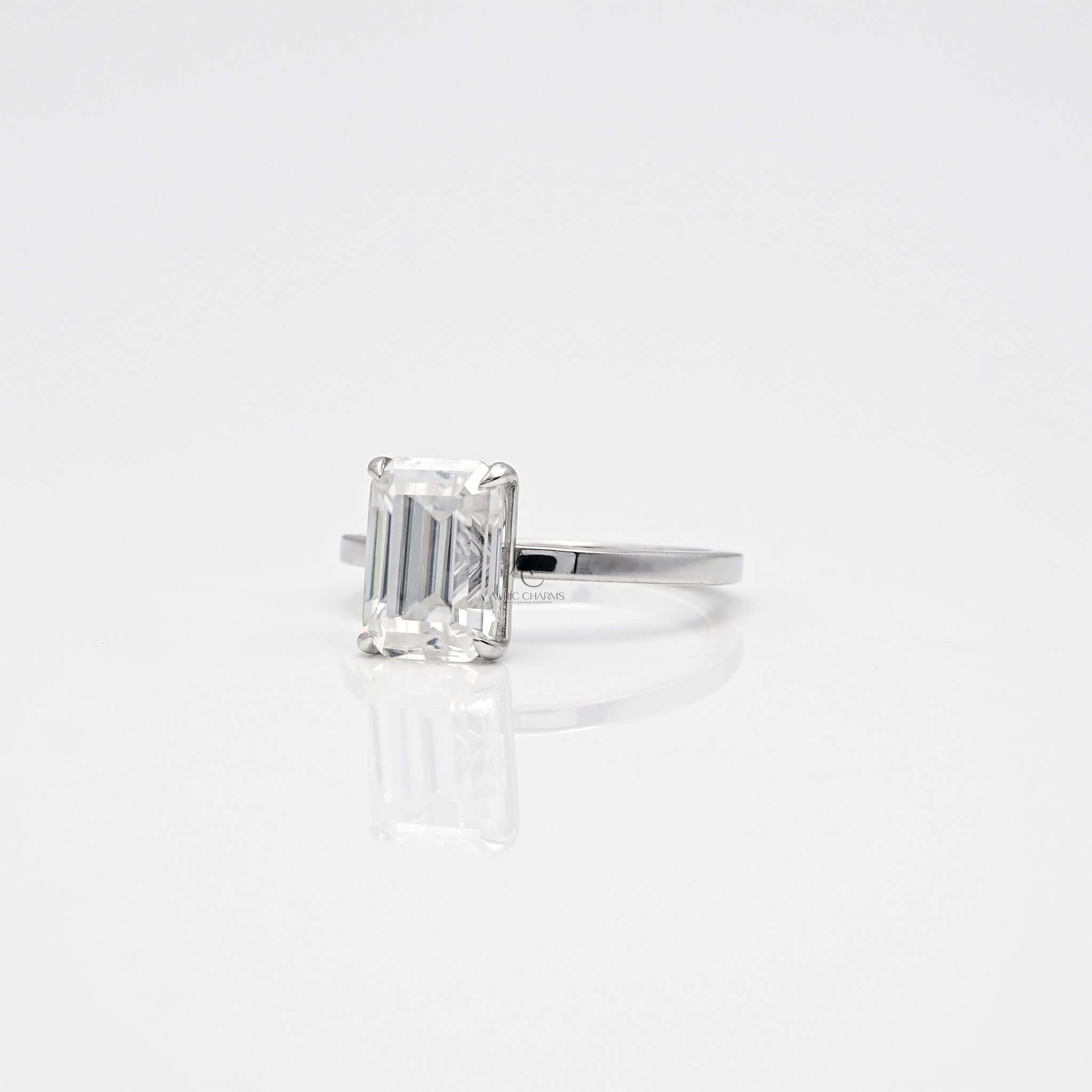 Side view of emerald-cut diamond solitaire ring.