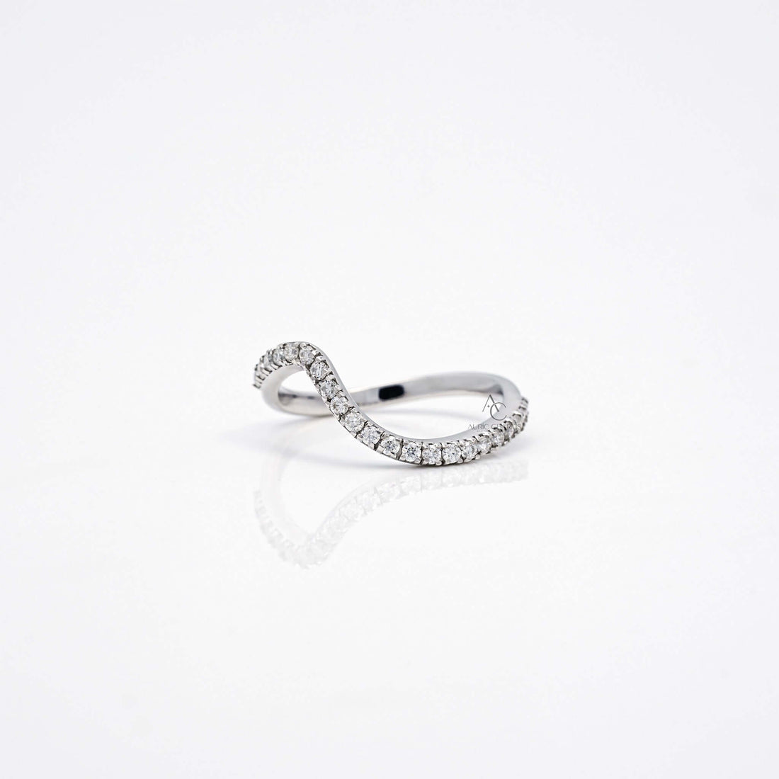 Side view of wavy diamond band showcasing curve and diamond setting.