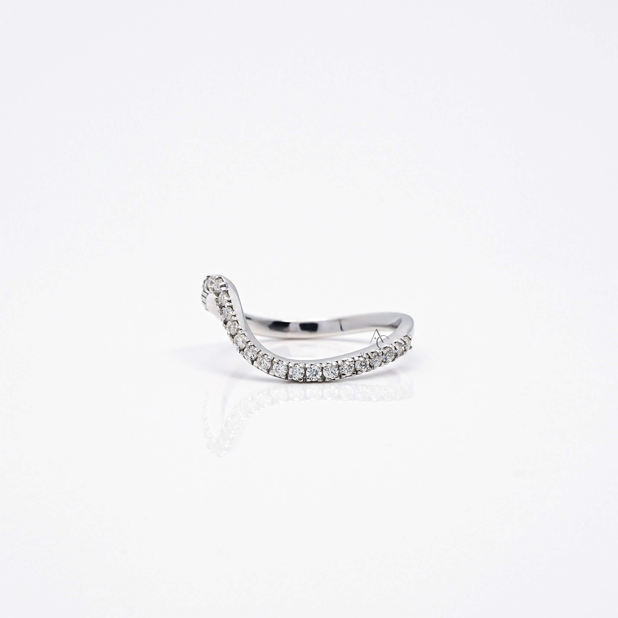 Angled side view of wavy diamond ring with full diamond setting.