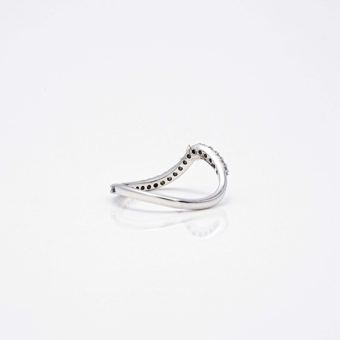 Angled back view of wavy diamond band showing intricate under-gallery.