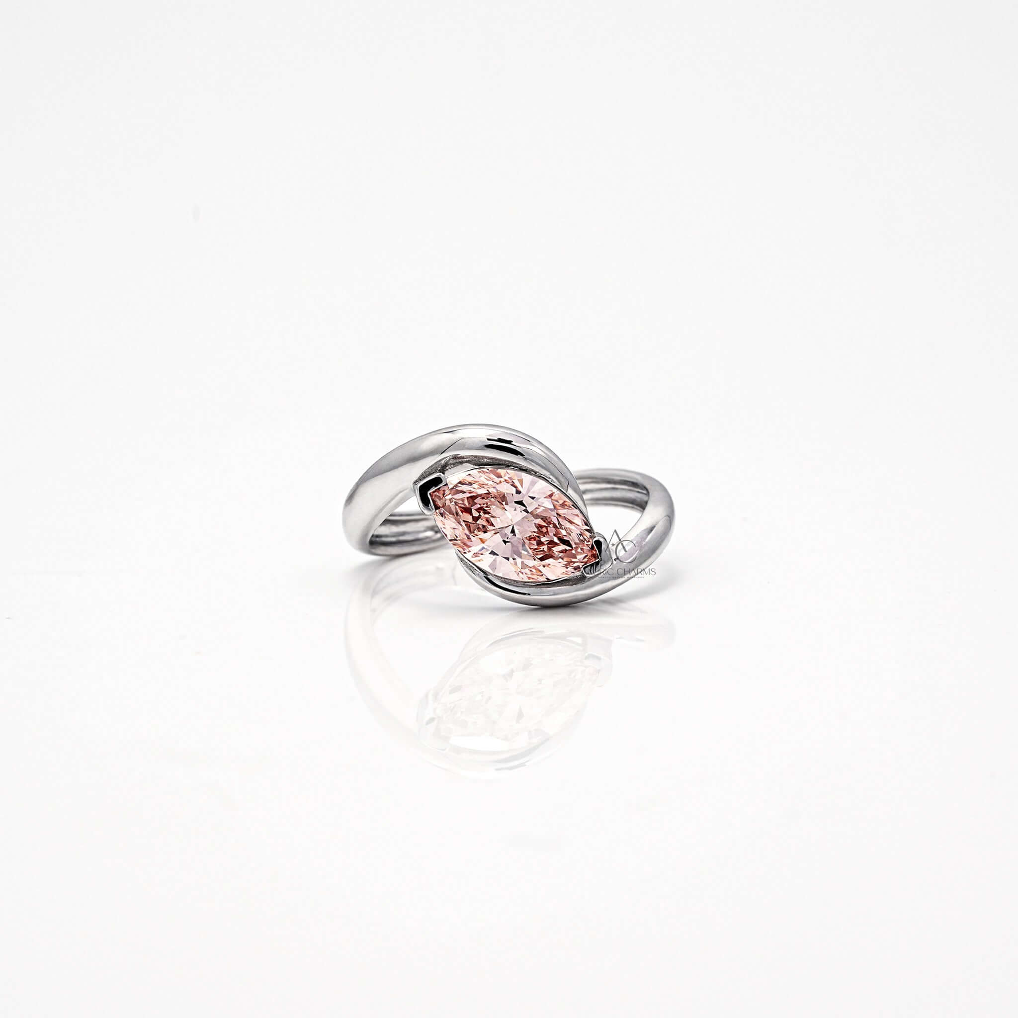 Marquise-cut pink diamond ring with a bypass band in white gold setting.