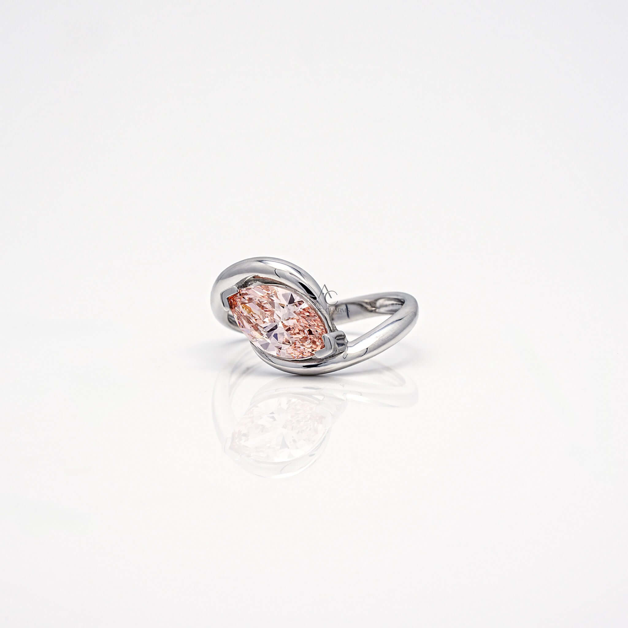 Angled side view of pink marquise diamond bypass ring in white gold.