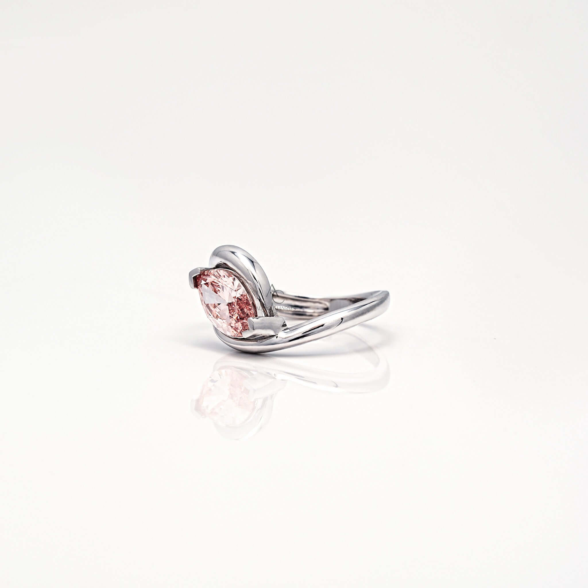 Side profile of pink marquise diamond ring with sleek white gold band.
