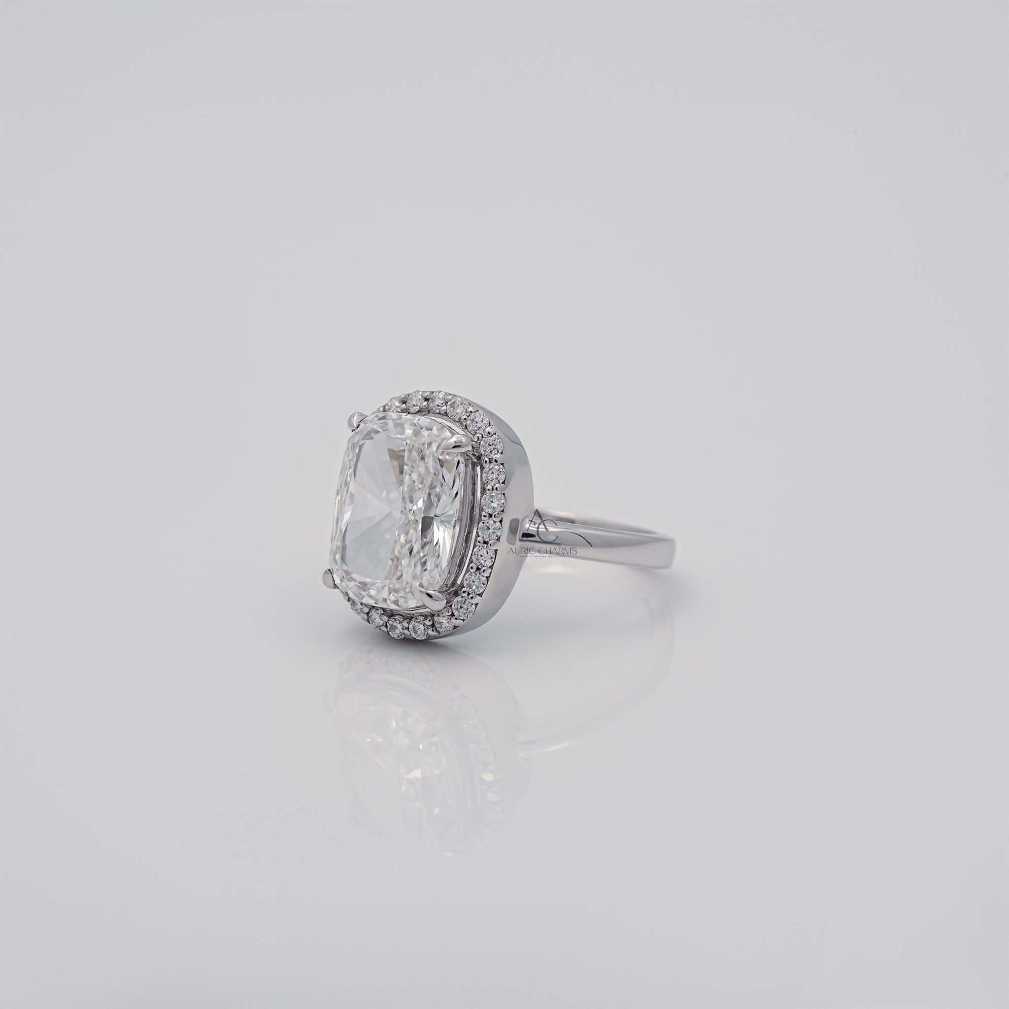 Angled side view of cushion-cut diamond halo ring.