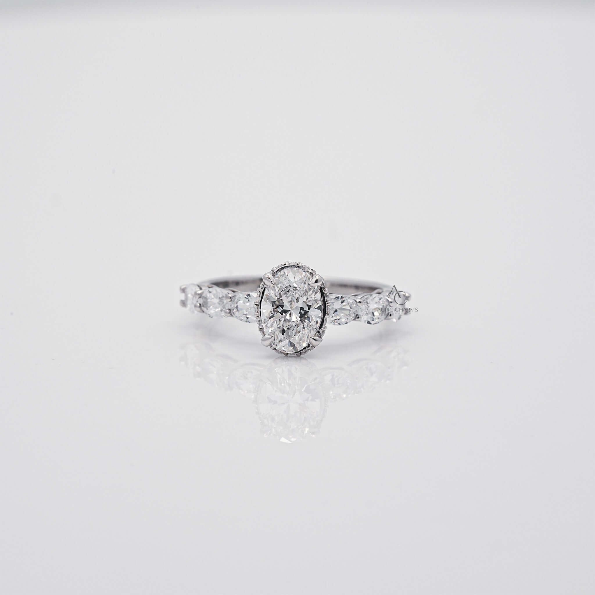 Oval cut diamond ring with side stones and sleek band, front view.