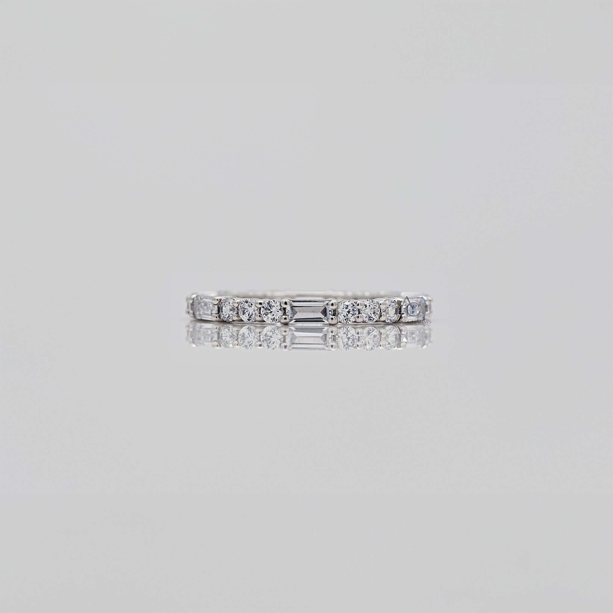 Diamond eternity band with alternating round and baguette diamonds.