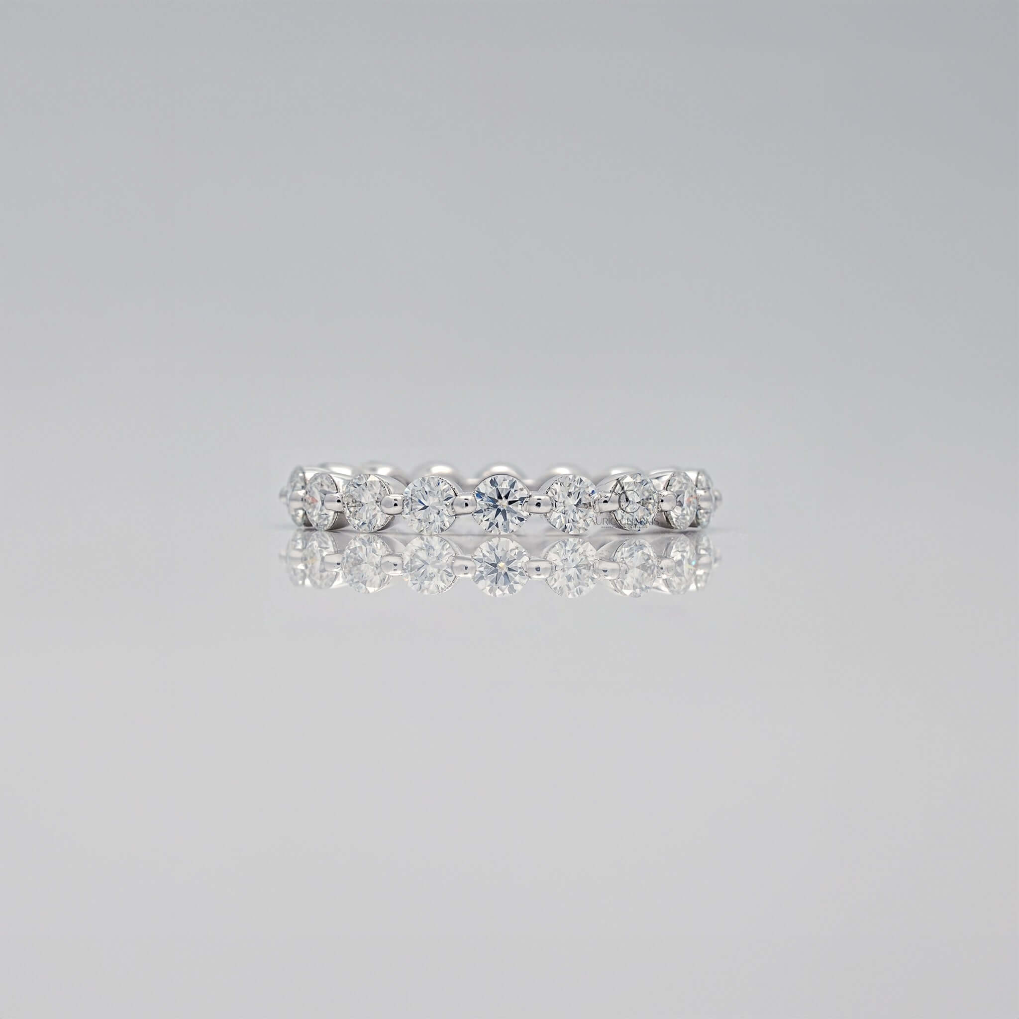 Side profile of diamond eternity ring in white gold.