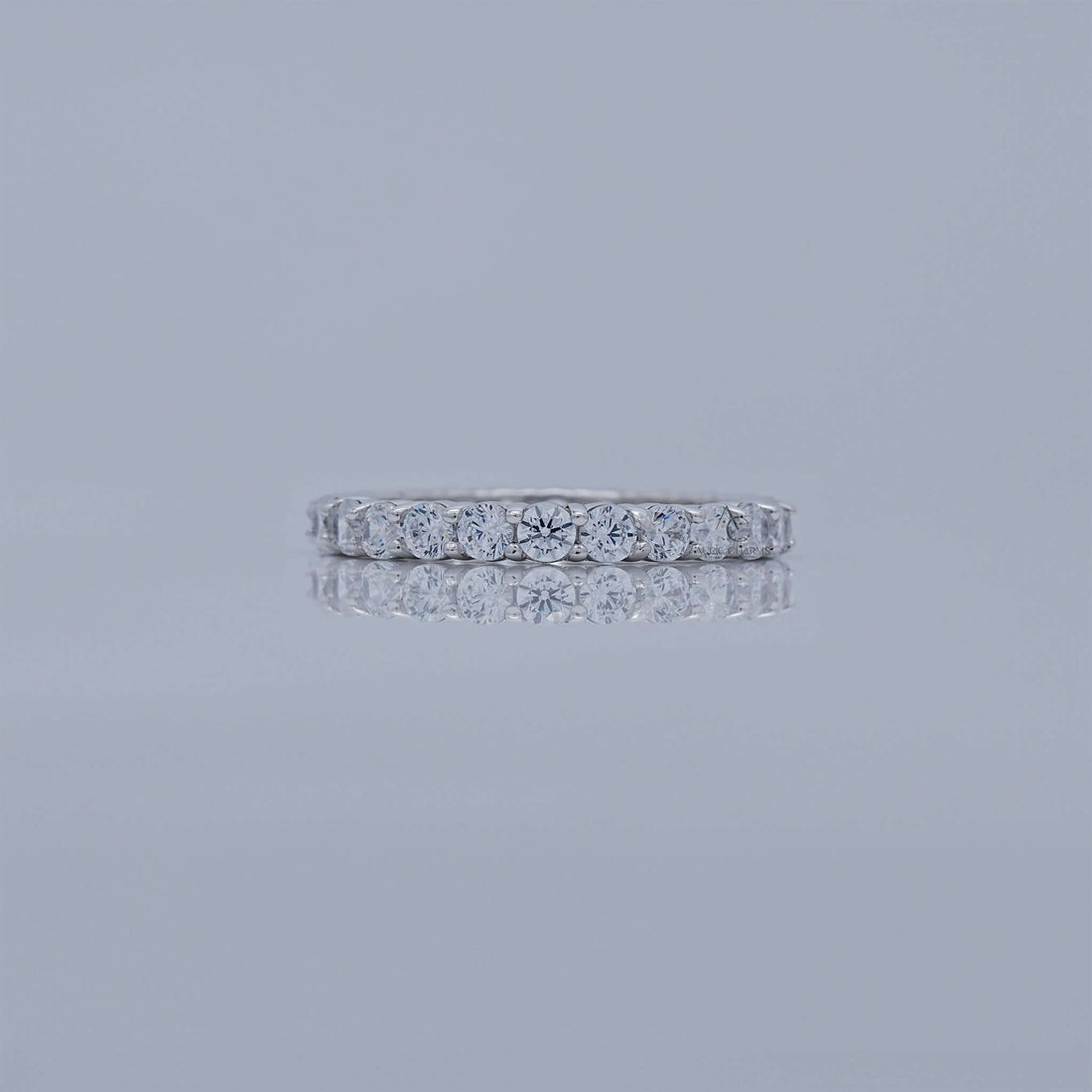 Diamond eternity band set in white gold, featuring a row of round diamonds.
