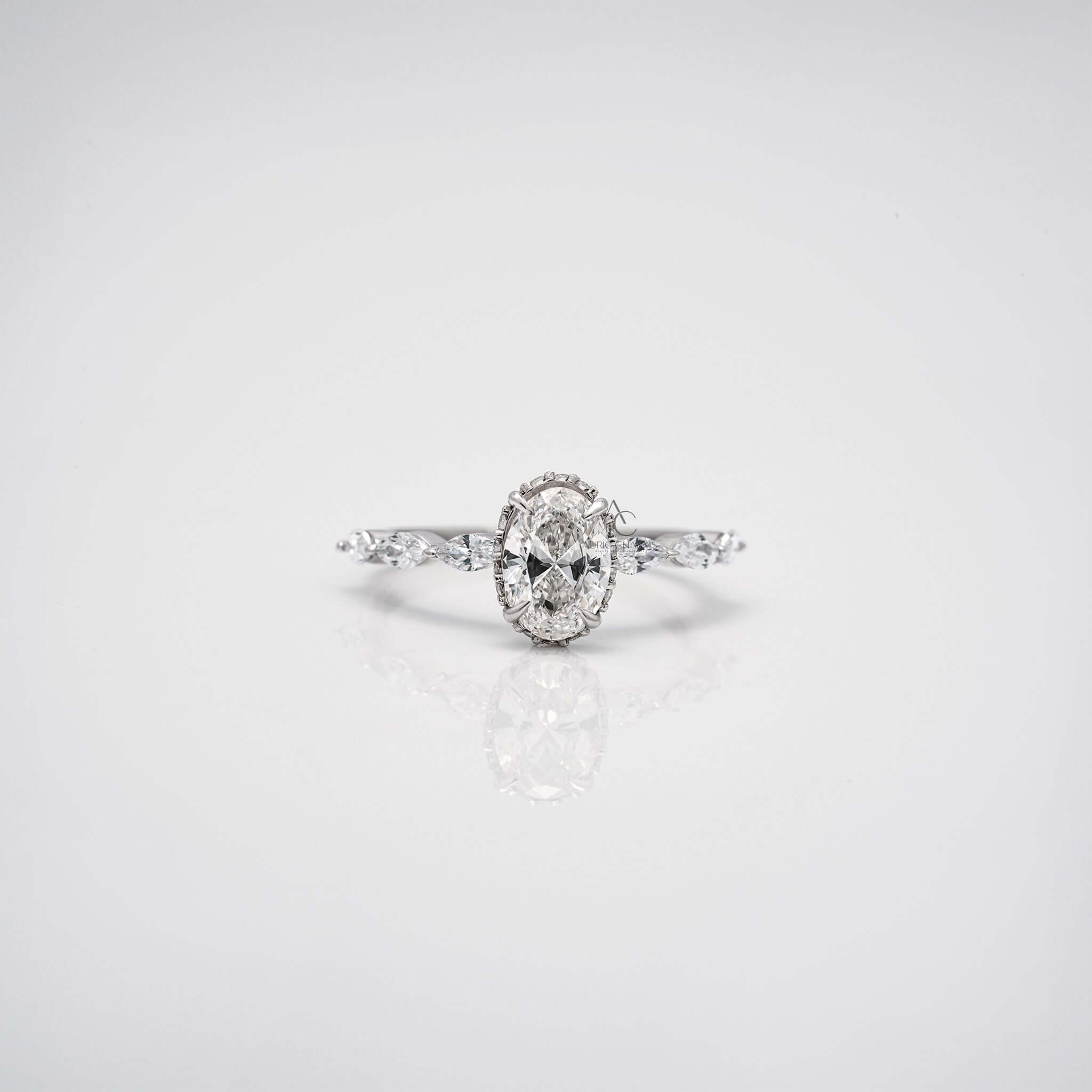 Close-up 360 view of oval diamond engagement ring with marquise side stones.