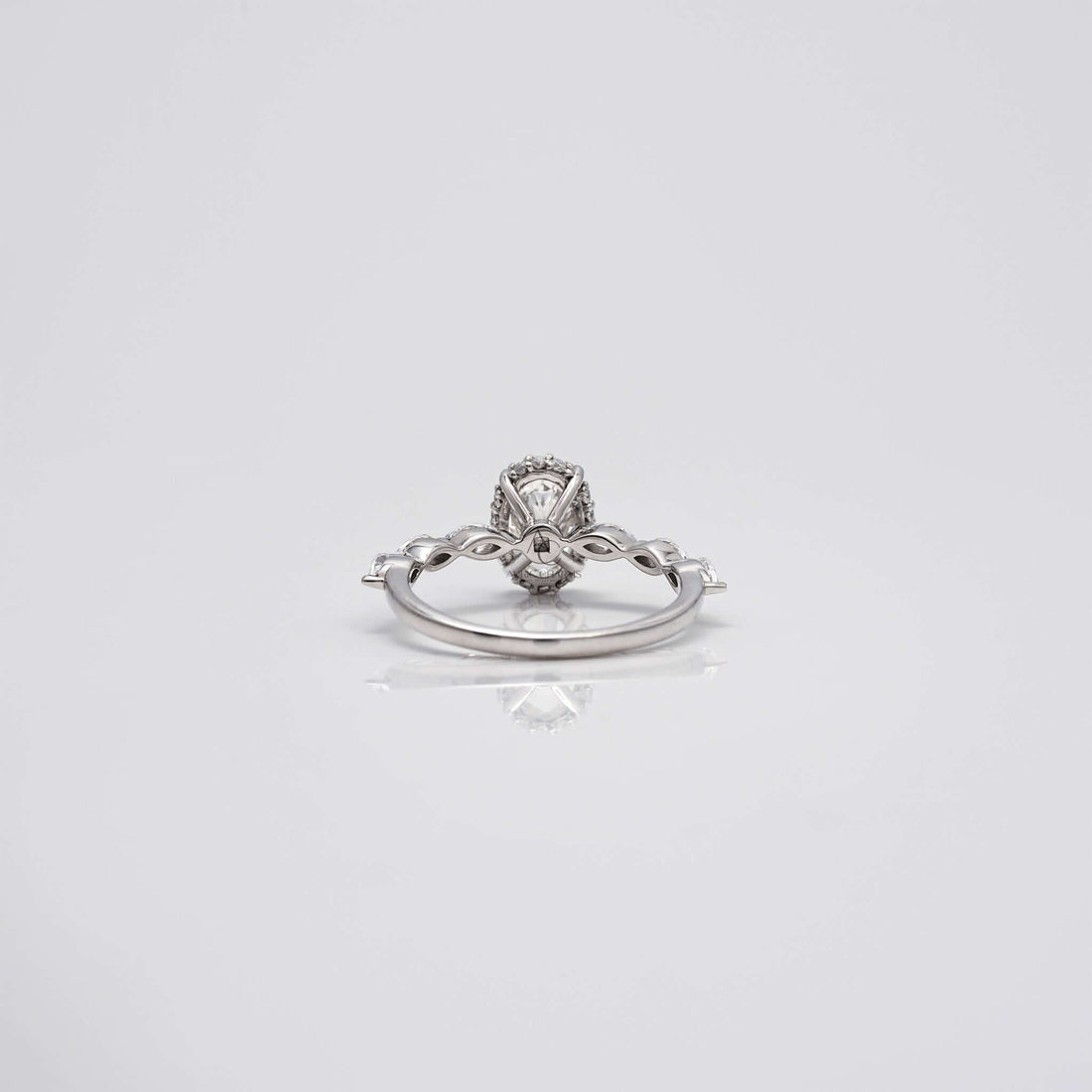 Back view of oval diamond ring with marquise band and gallery details.