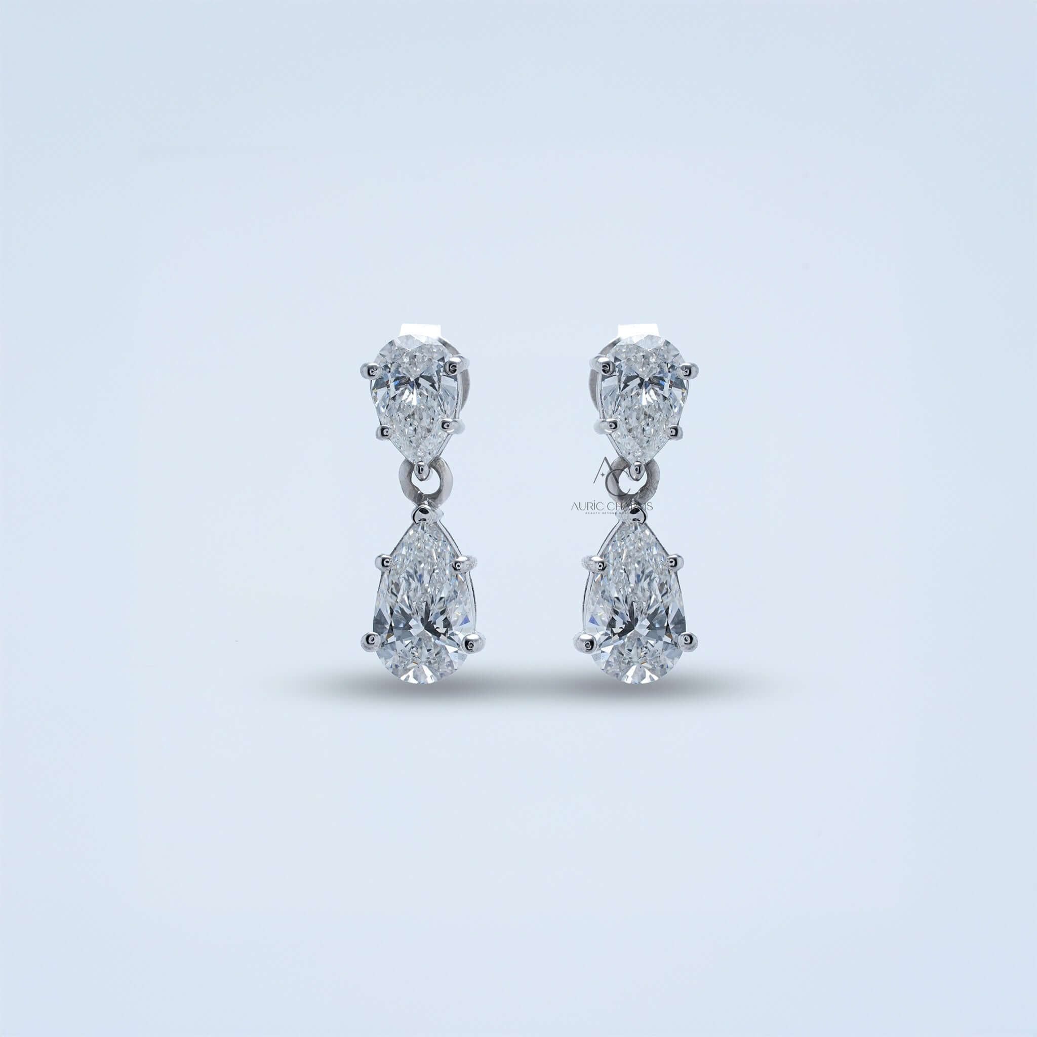 Close-up of double pear diamond earrings, showcasing the polished prong setting.
