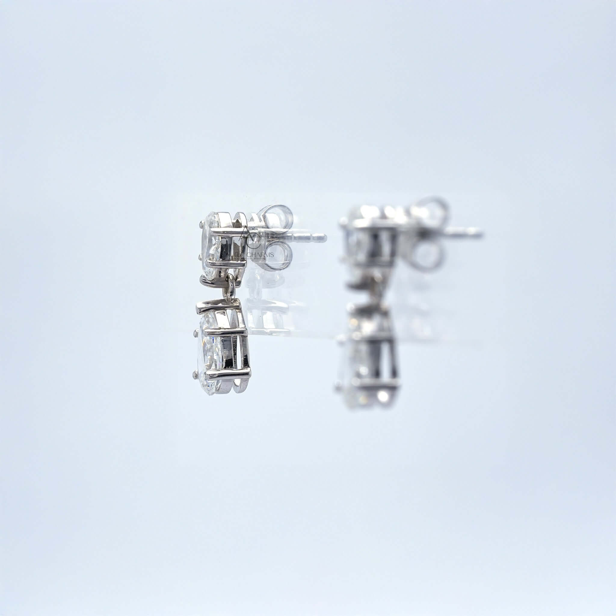 Side view of pear-cut diamond earrings, highlighting the secure prong setting.