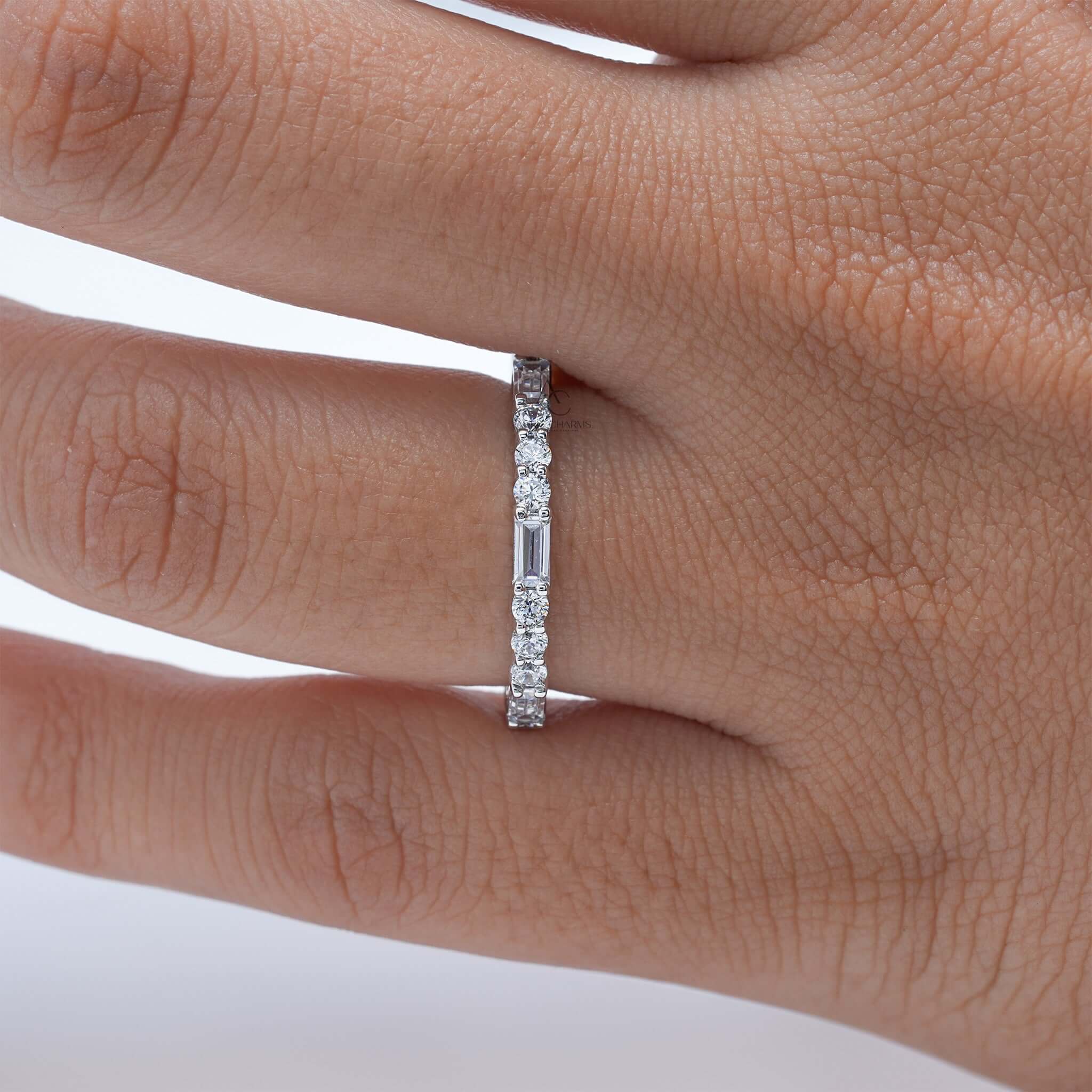 Diamond eternity band on finger showing intricate design and sparkle.