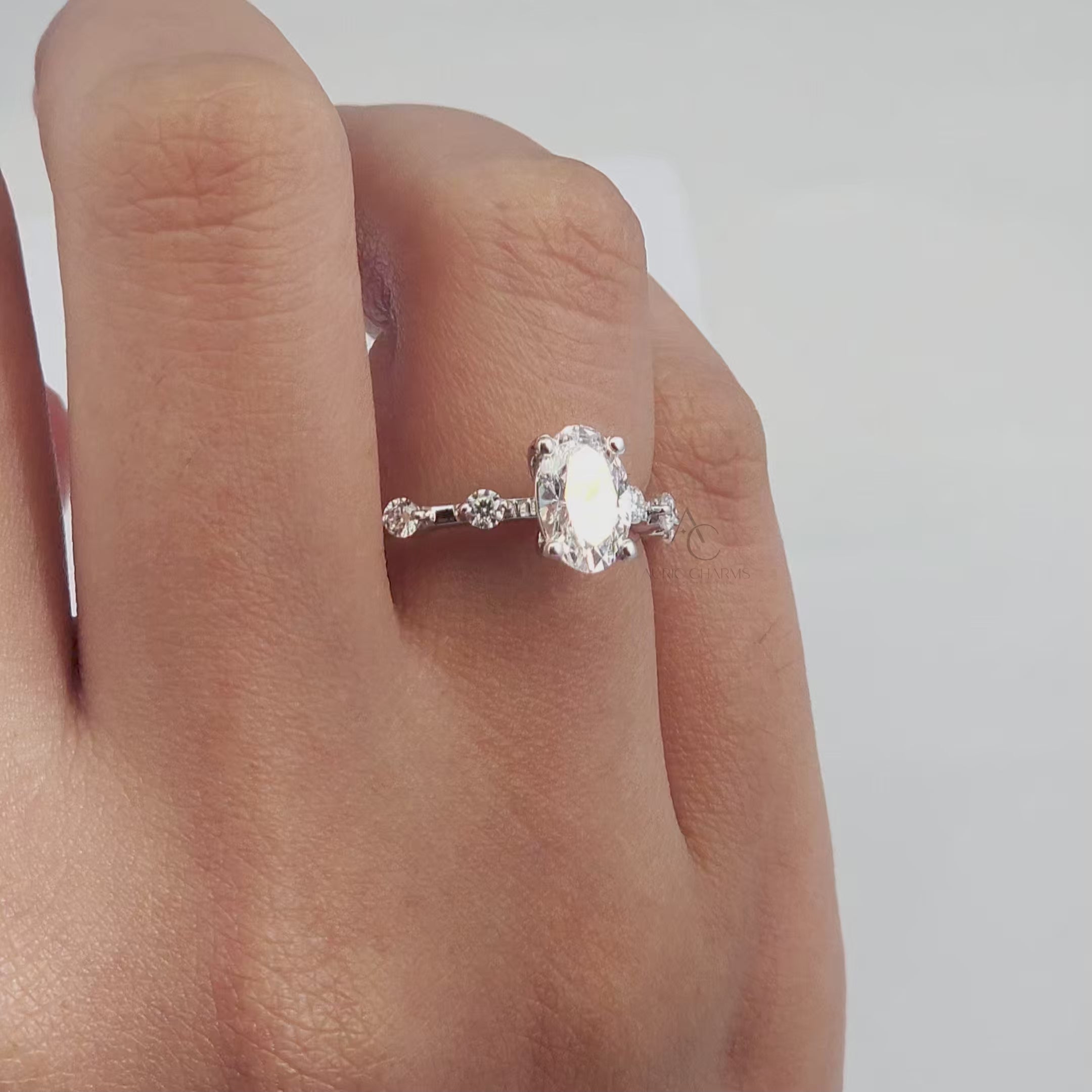 360-degree view of an oval-cut diamond engagement ring with a delicate band and brilliant sparkle.