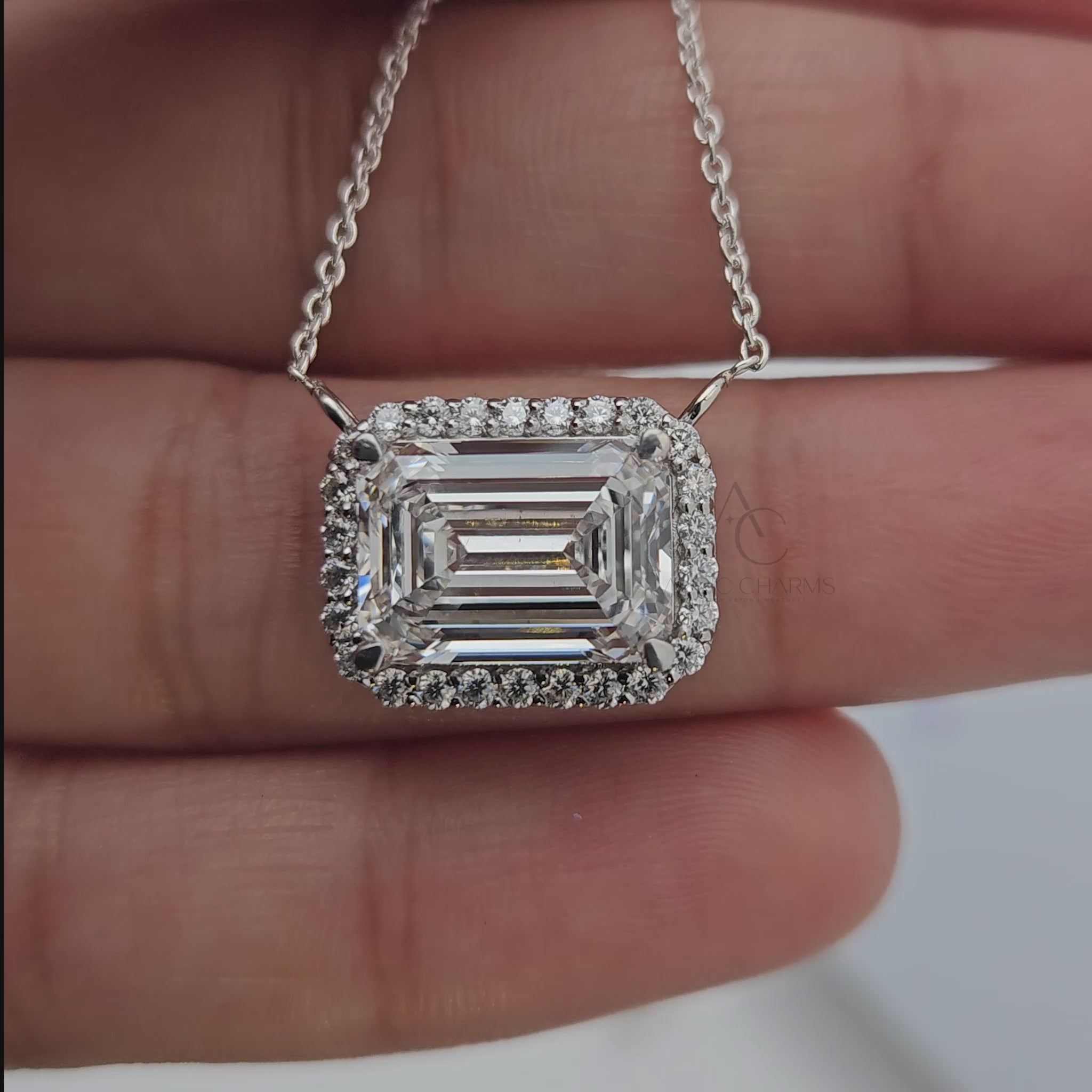 Emerald cut diamond pendant with halo setting showcased from multiple angles.