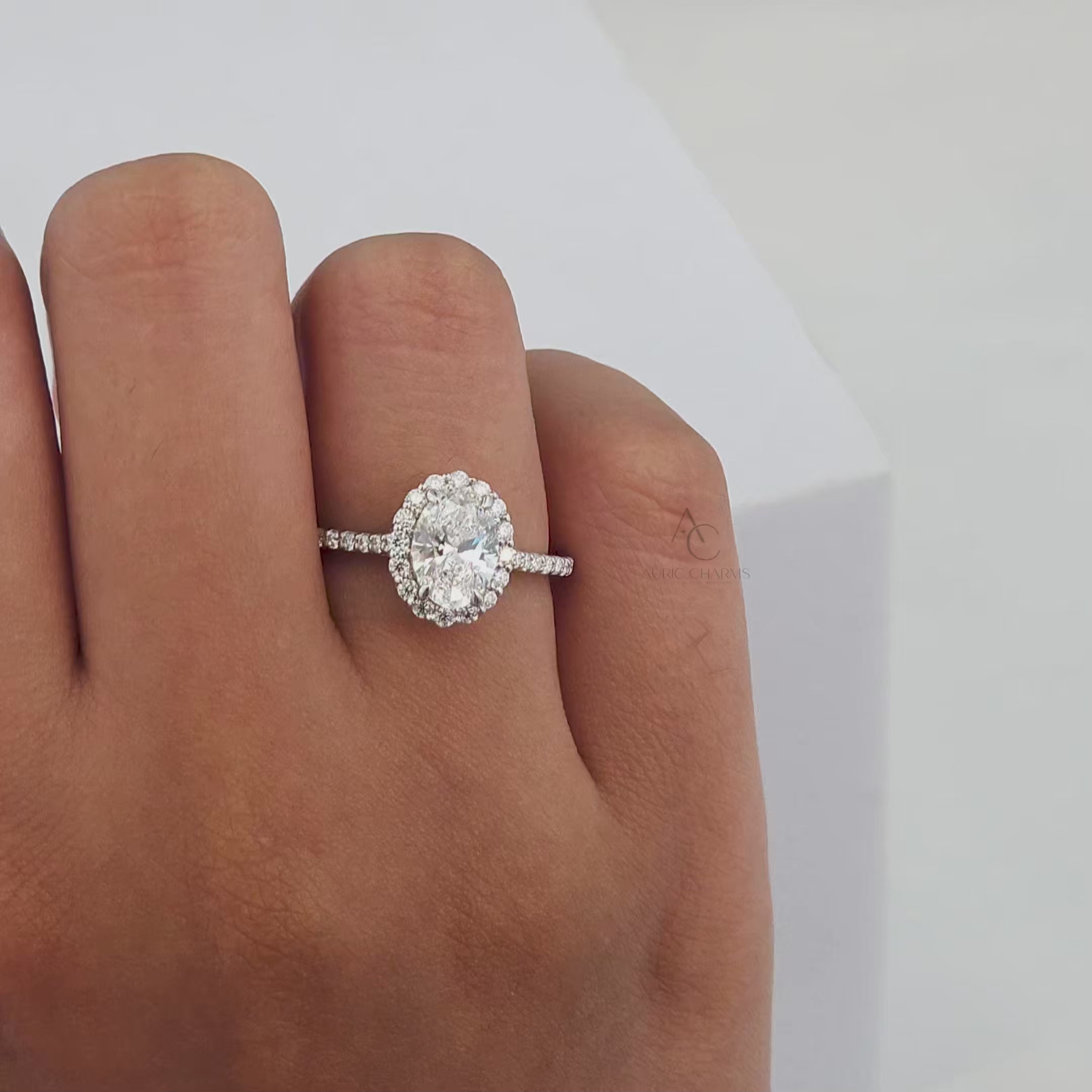 360-degree video of an oval-cut diamond ring with a halo and diamond pavé band.