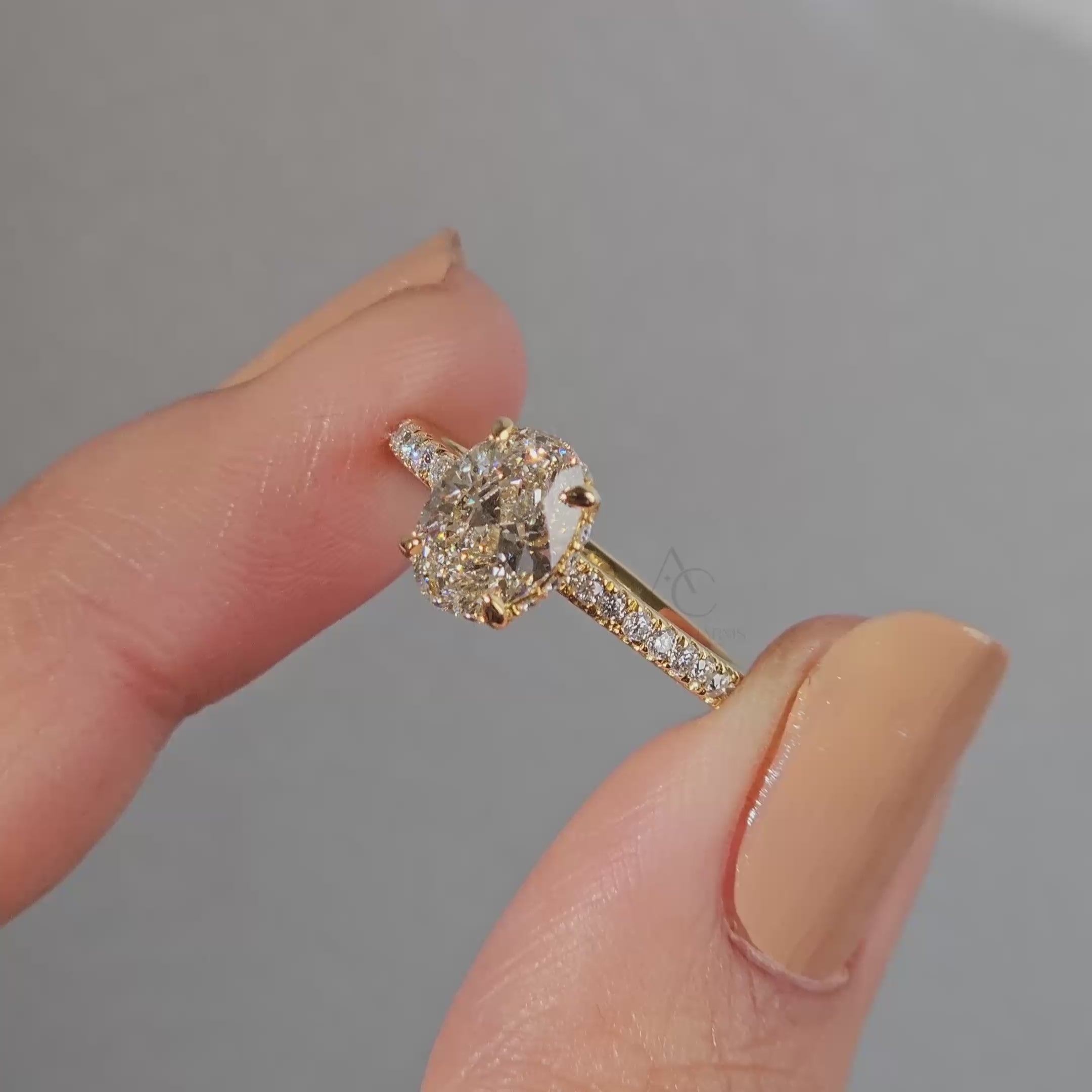 Close-up of oval lab-grown diamond ring showcasing its brilliance and intricate pave setting.