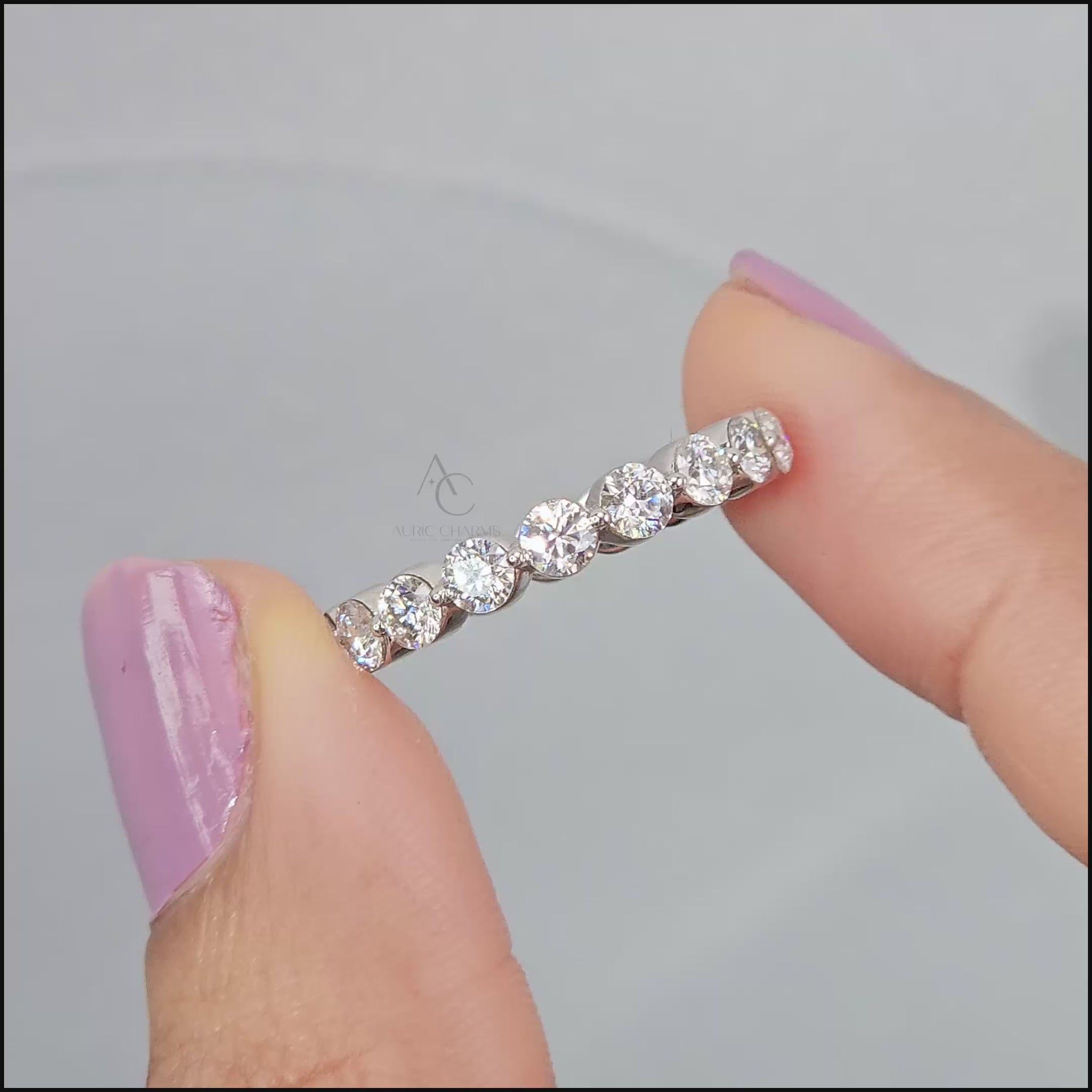 A white gold eternity ring featuring a continuous row of round-cut diamonds