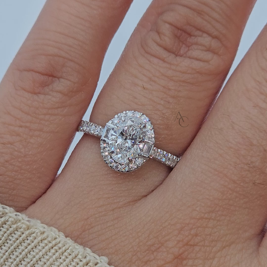 Rotating view of oval diamond ring with halo and pave band under light.