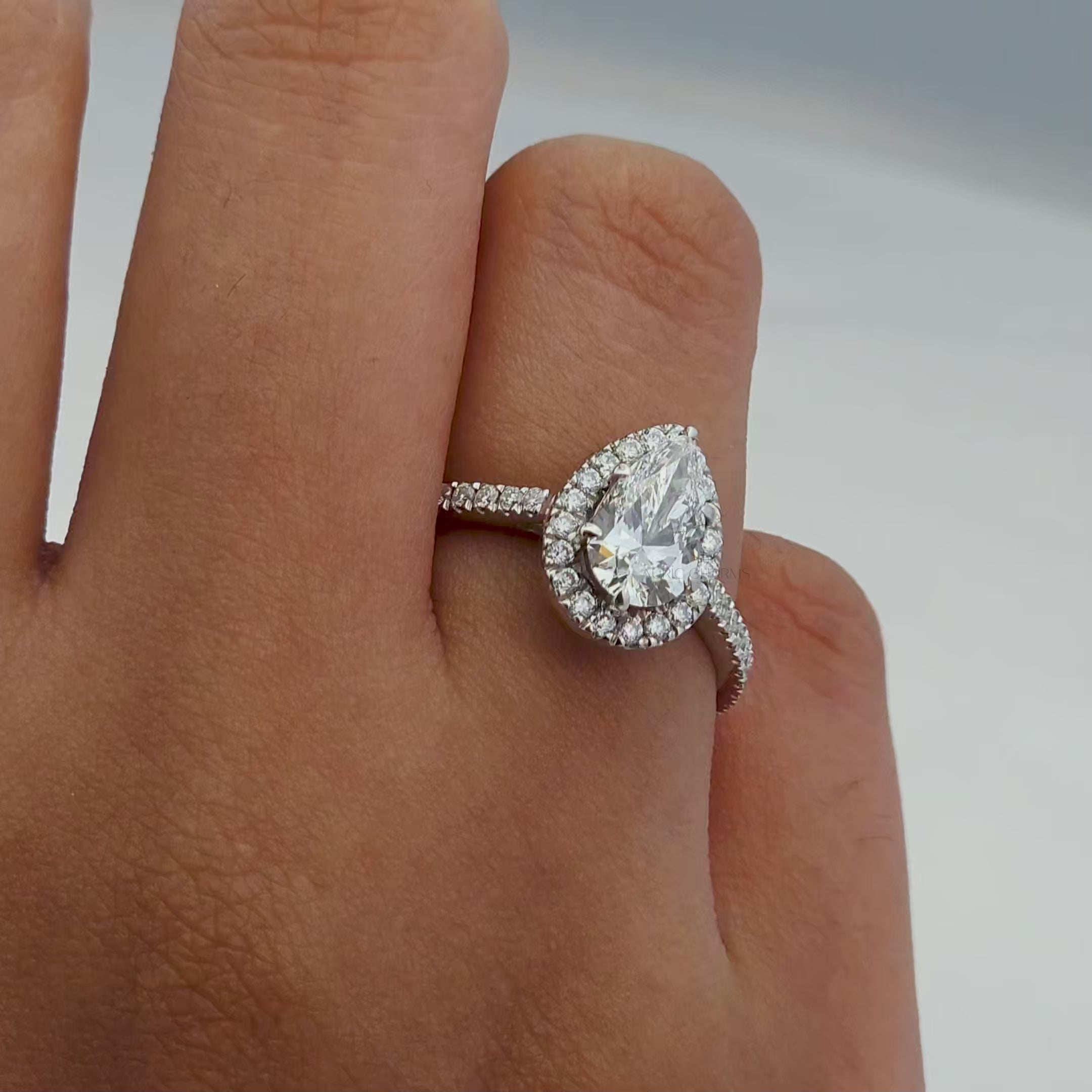 Rotating view of a pear-cut diamond ring with halo design and detailed craftsmanship.
