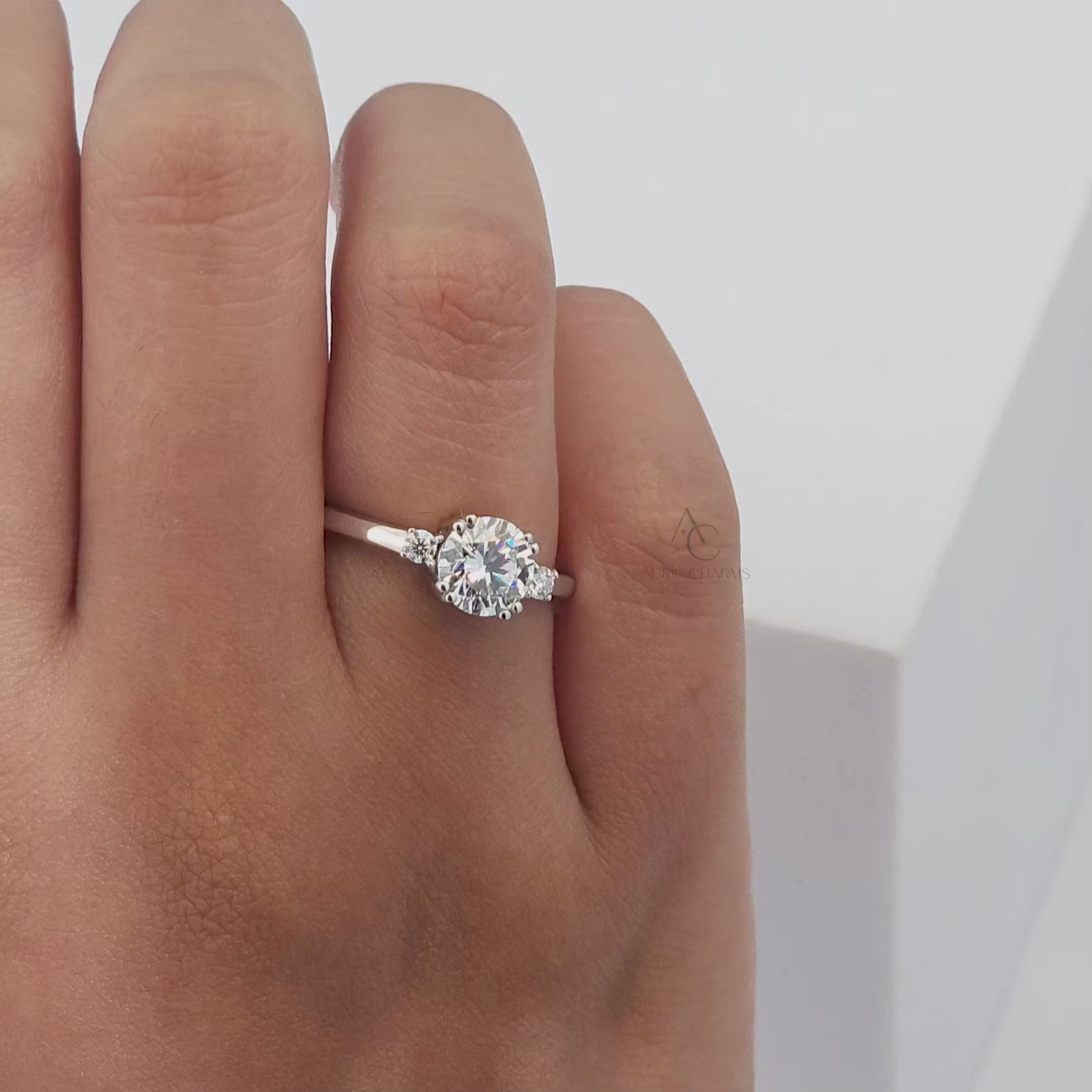 A 360-degree view of a dazzling round-cut diamond engagement ring, highlighting the brilliance of the stones and the sleek band design.