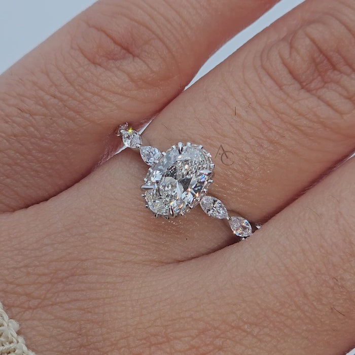 360 view of oval diamond ring with marquise side stones.