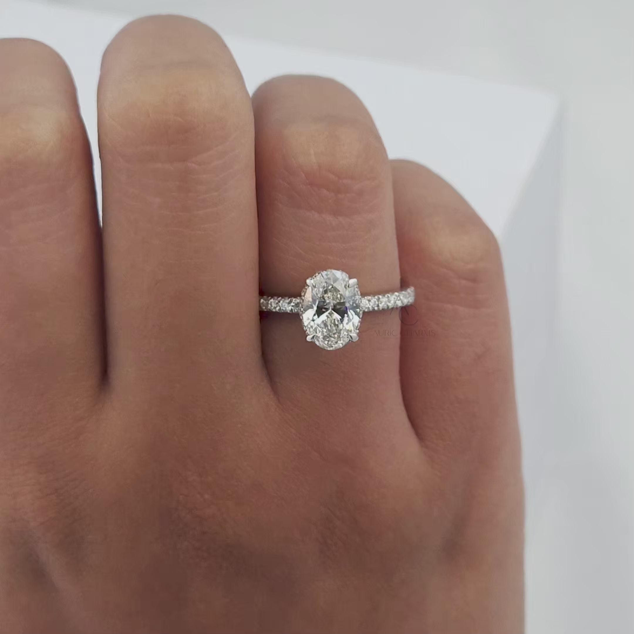 Rotating view of oval diamond solitaire ring showcasing brilliance and pave detailing in motion