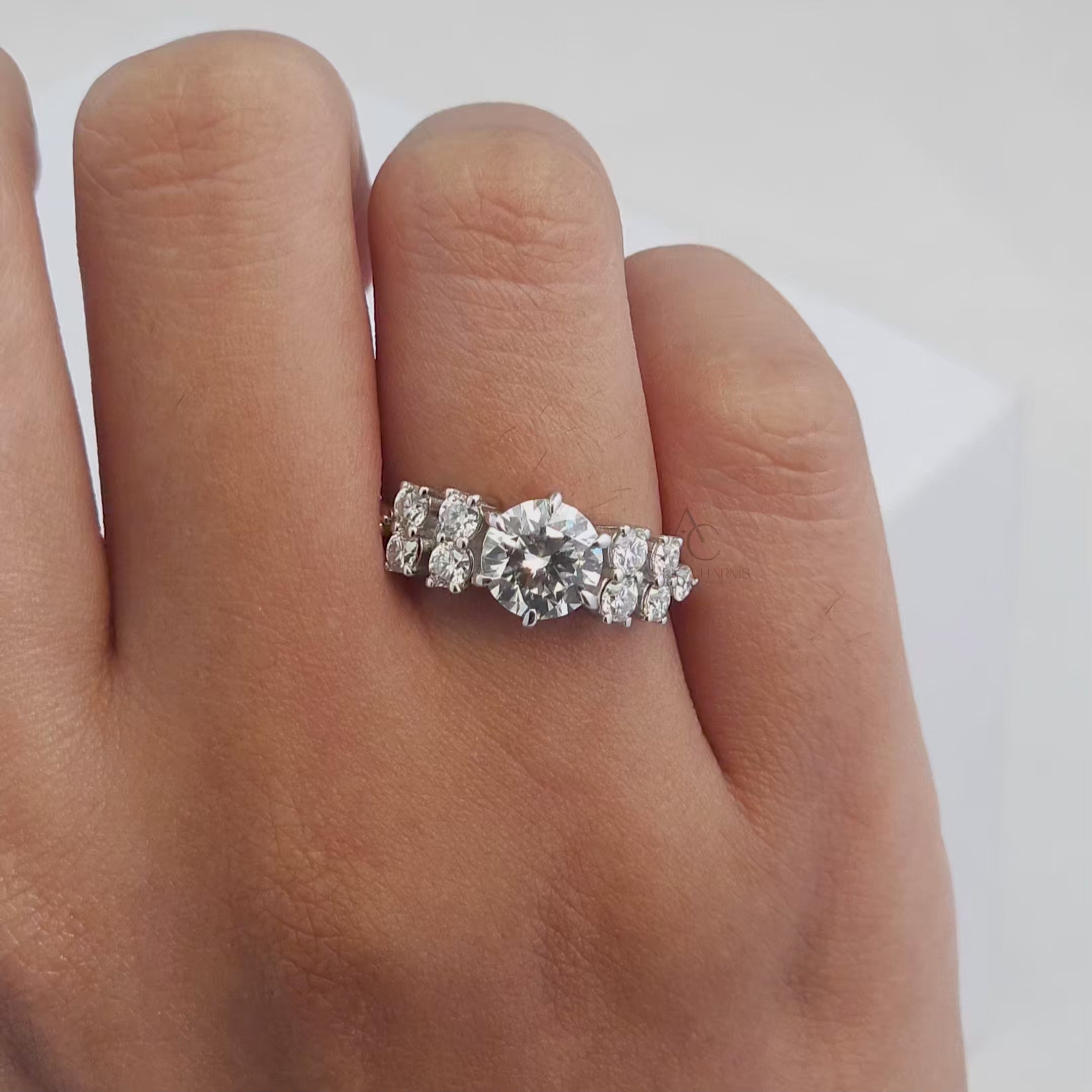 360-degree view of a round brilliant diamond solitaire ring with sparkling side accents, platinum setting.