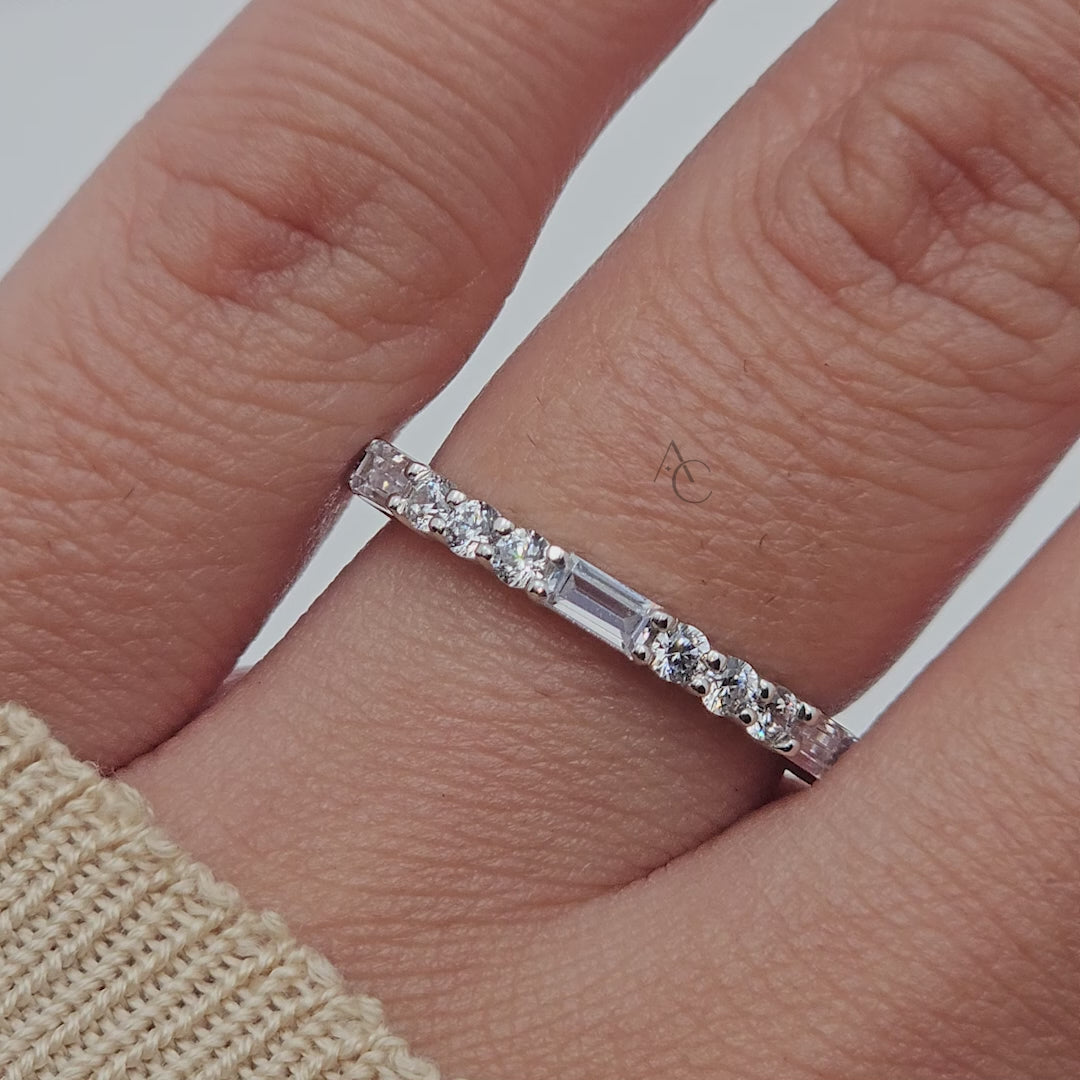 Close-up of diamond eternity band with alternating round and baguette diamonds.