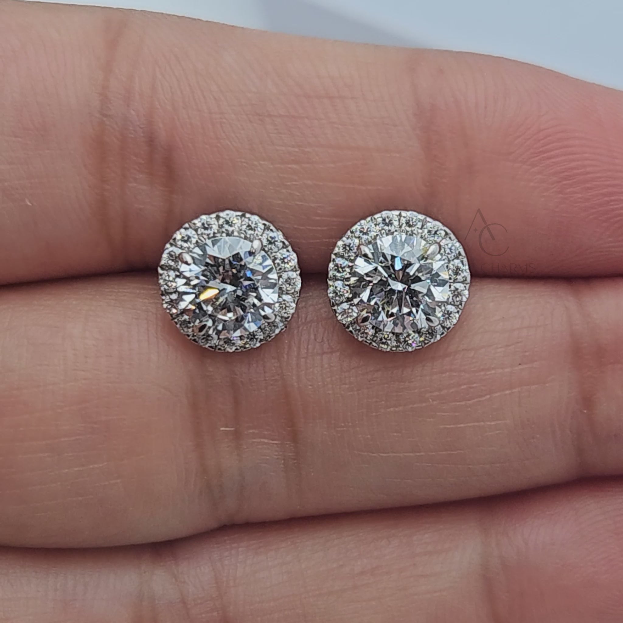 Rotating view of round brilliant halo lab-grown diamond stud earrings set in white gold.