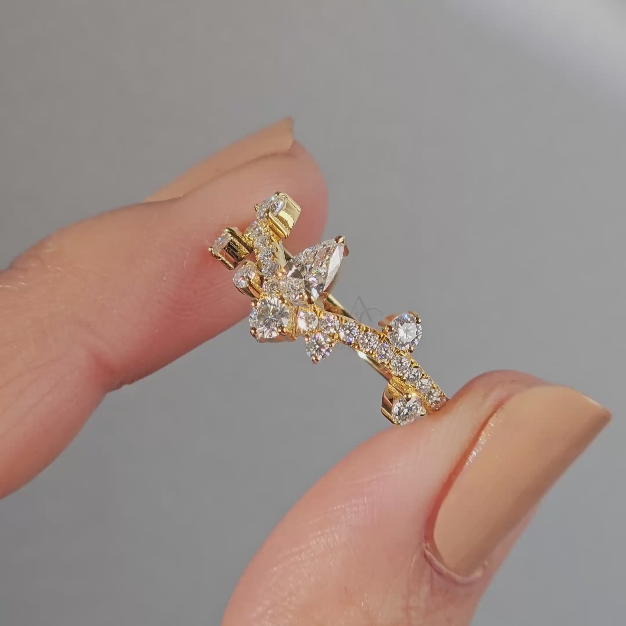 360 view of a diamond crown ring showcasing its unique pear-shaped diamond setting.