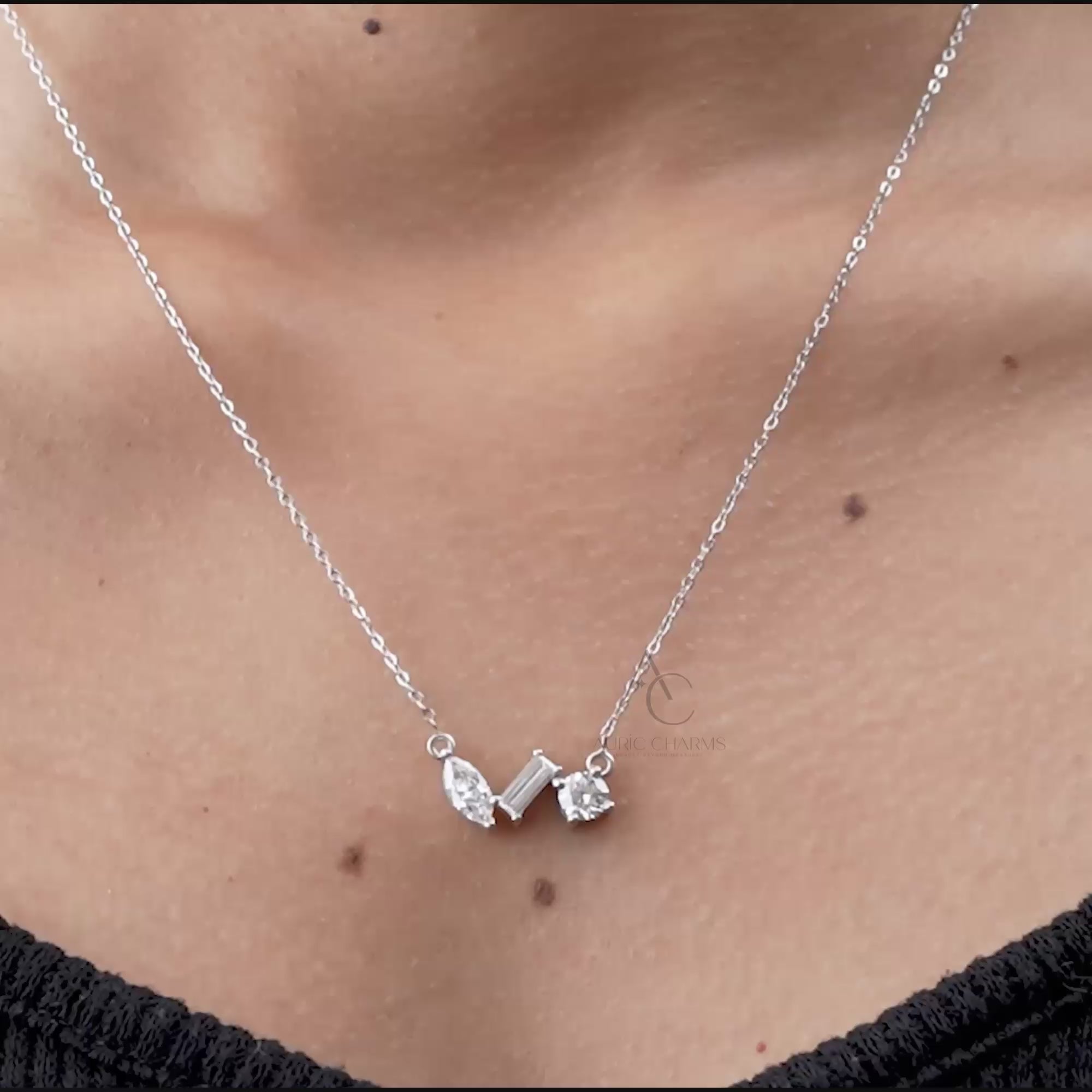 Elegant lab grown diamond trio pendant necklace worn on the neck, featuring round, marquise, and baguette cuts in a fine silver setting.