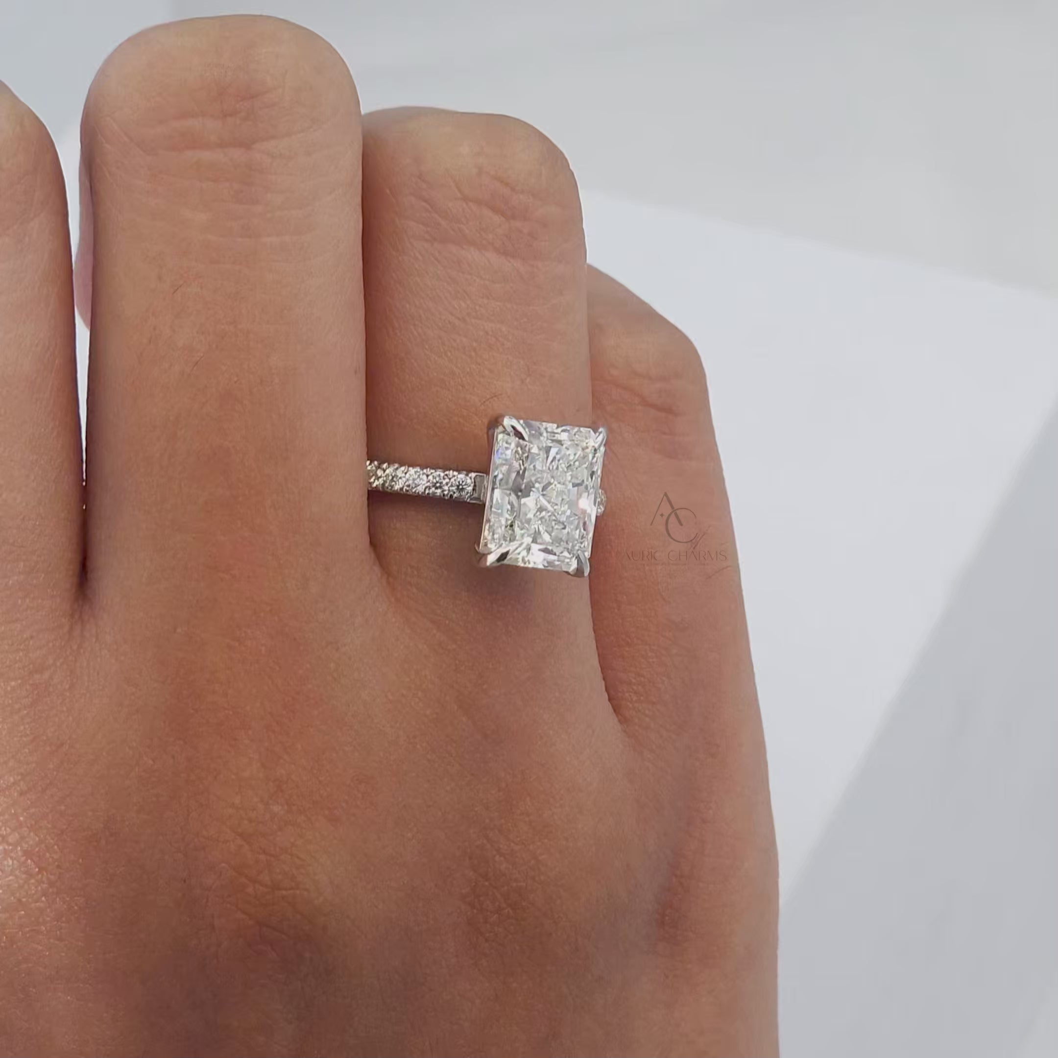 360-degree view of a radiant-cut diamond ring with a diamond-encrusted band.