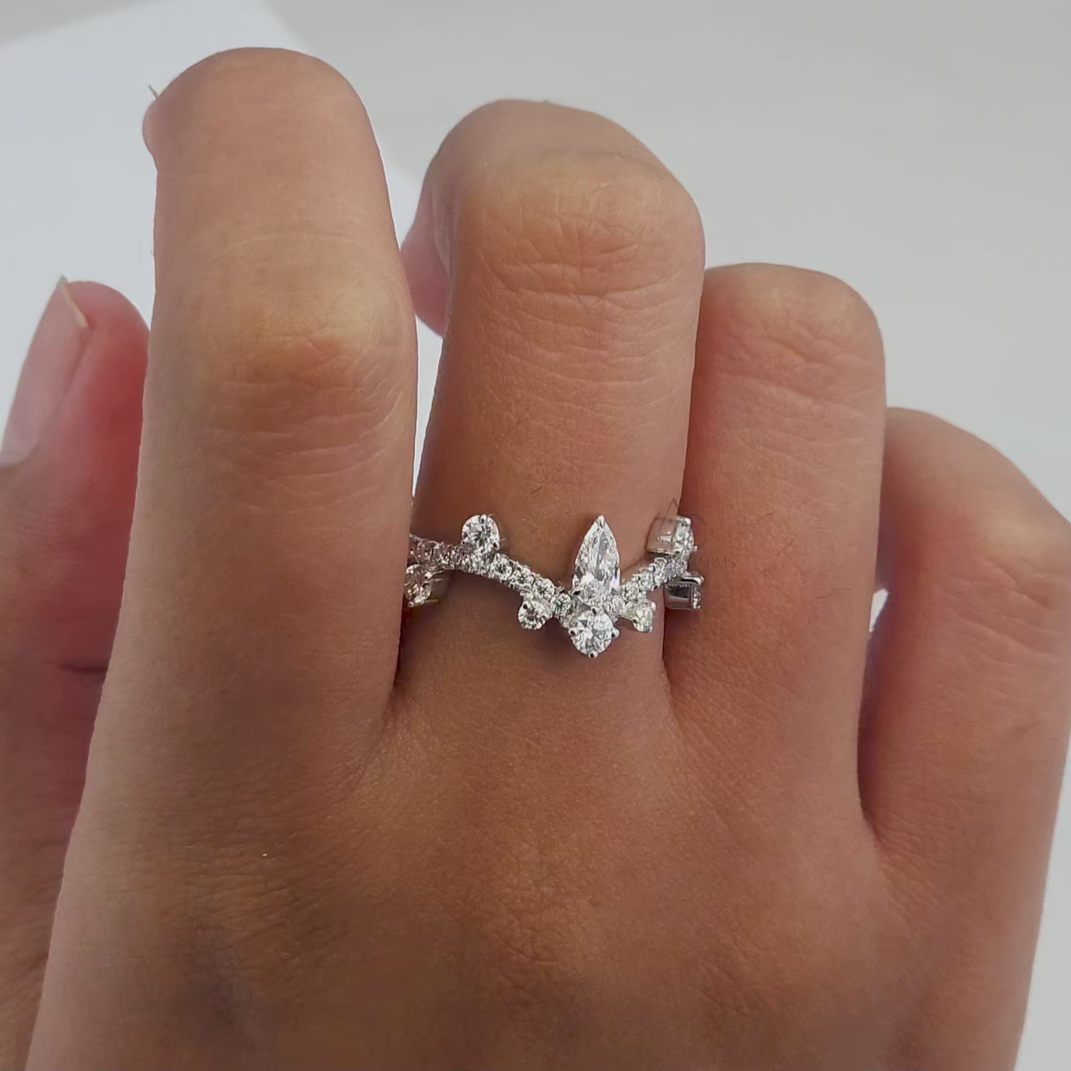 360-degree view of a pear-shaped diamond crown ring with sparkling diamonds, highlighting its intricate design.