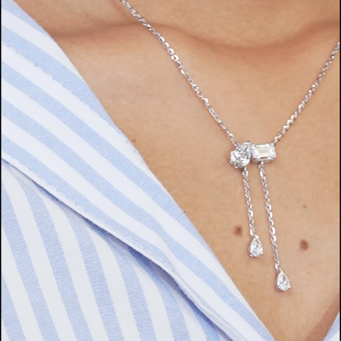 Elegant Toi et Moi pendant necklace with lab-grown diamonds, featuring emerald and pear cut, worn on neck, embodying luxury.